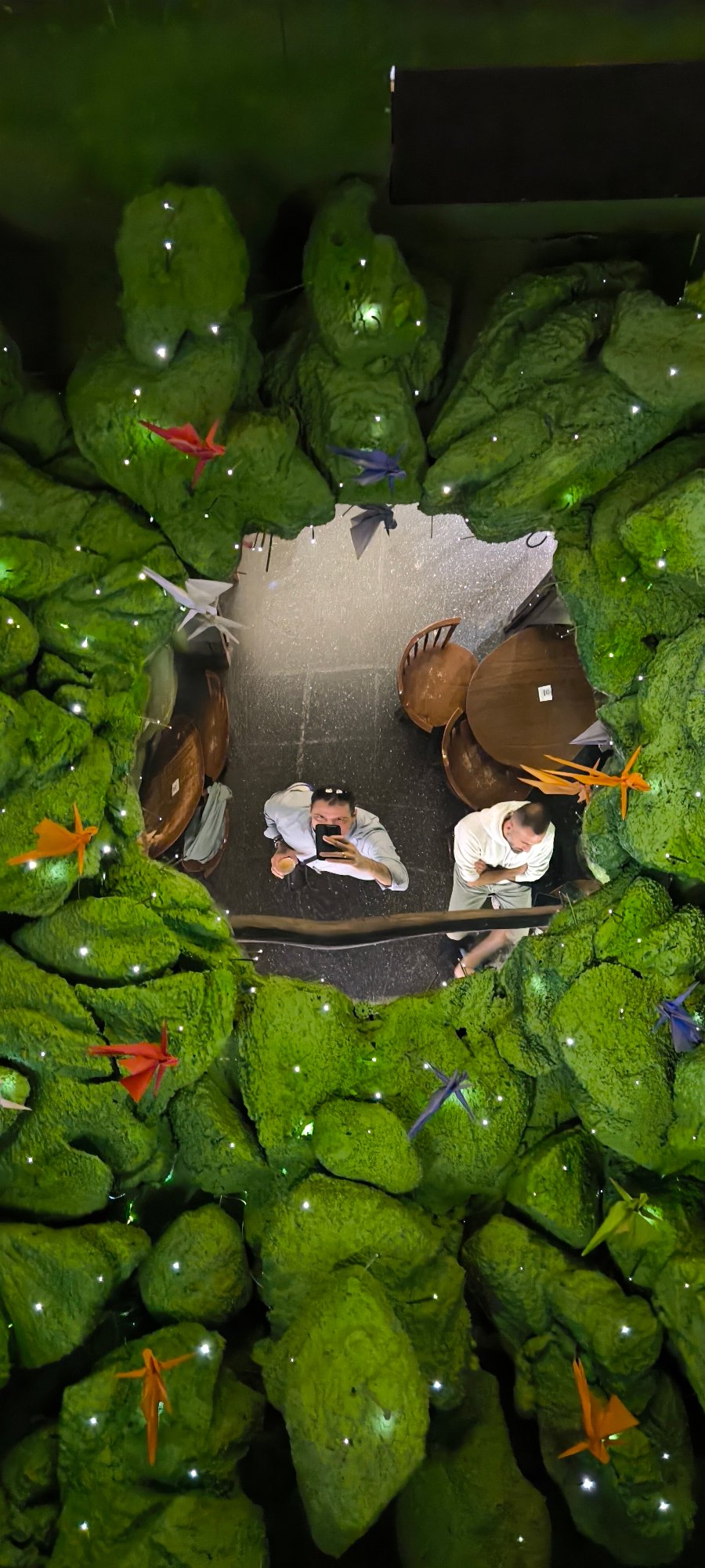 Two diners reflected in decorative mirror at Barcelona restaurant