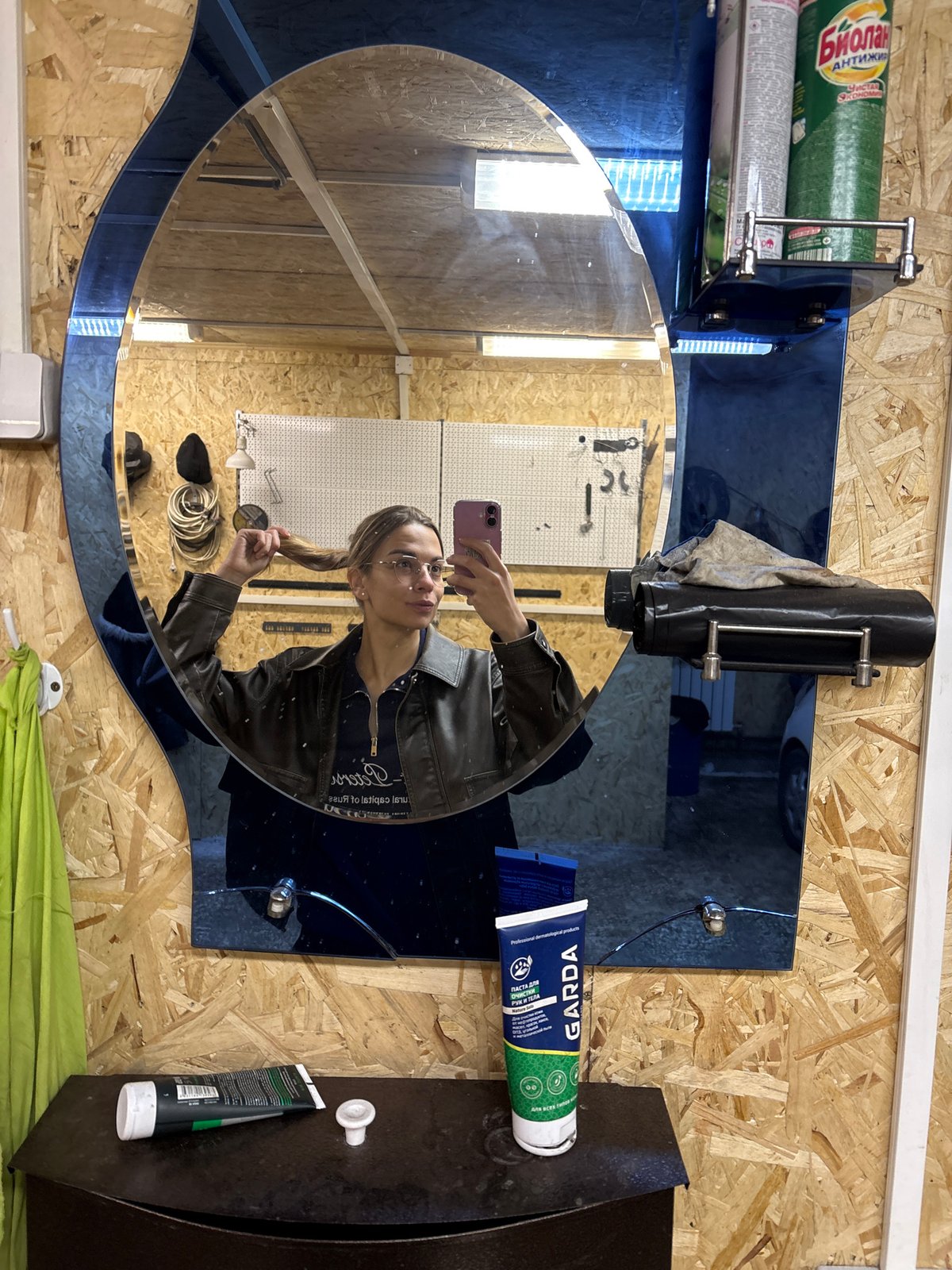 Person Takes Selfie in Blue-Framed Mirror in Ust-Ilimsk
