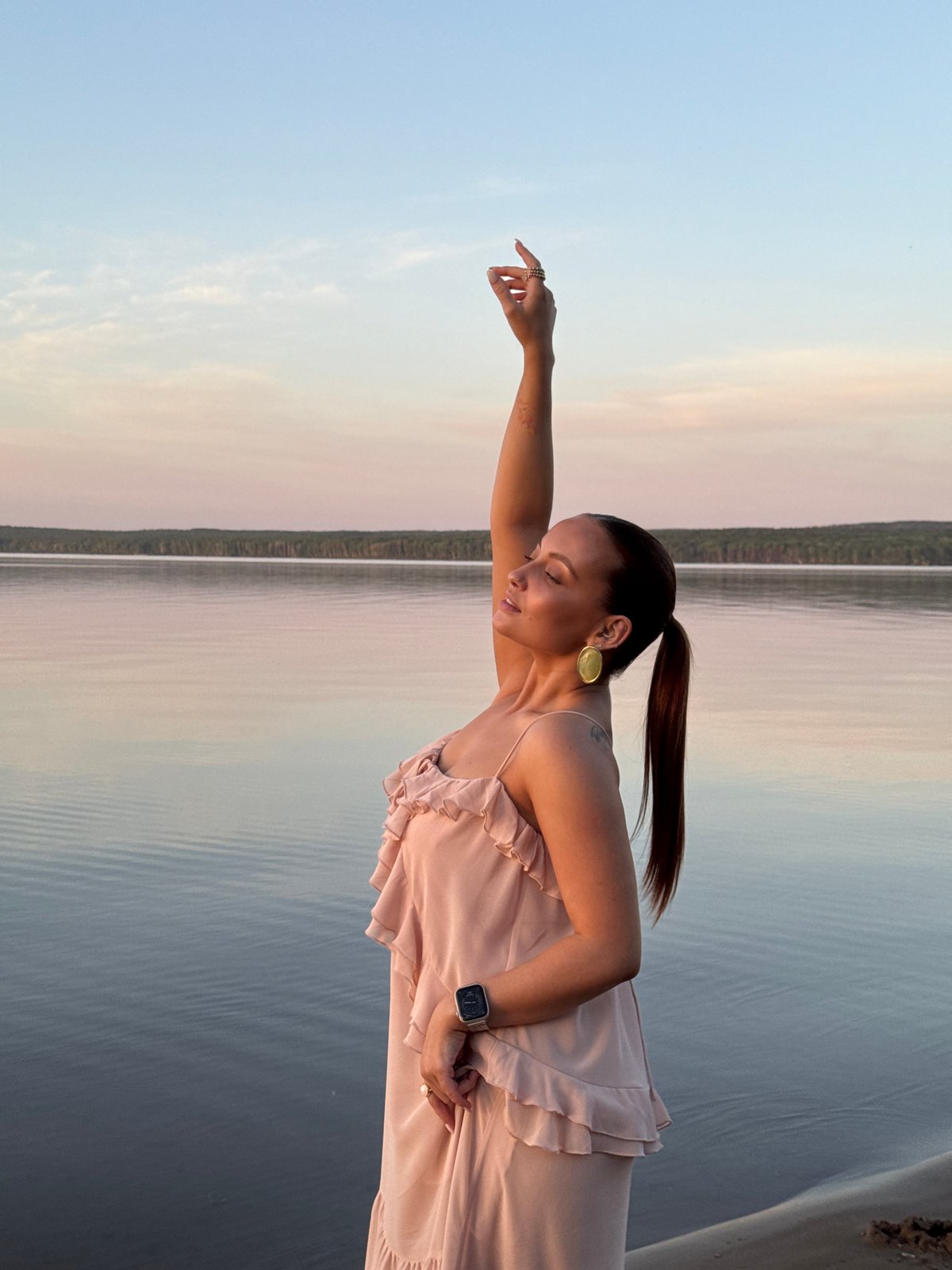 Woman poses for lakeside photo session in Chaikovsky, Russia