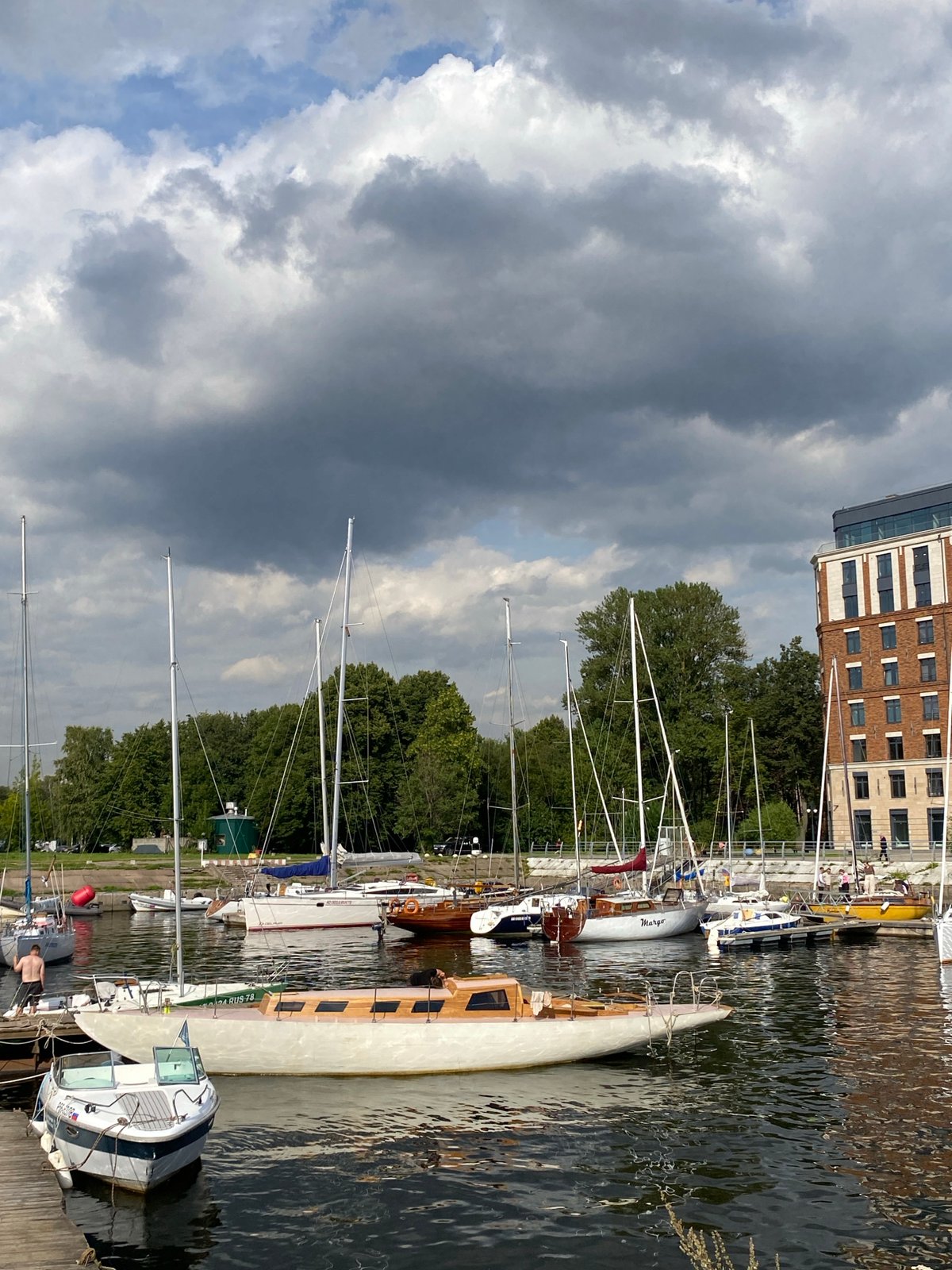 Saint Petersburg marina: sailboats, a crane lift, and river traffic