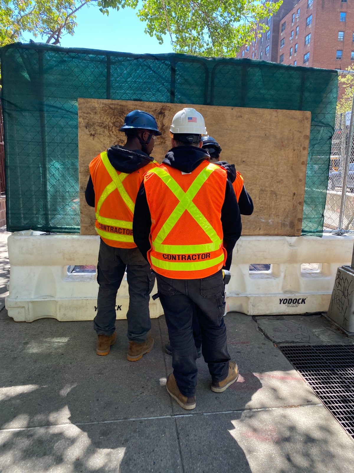 Construction workers spotted on NYC sidewalk wearing safety gear