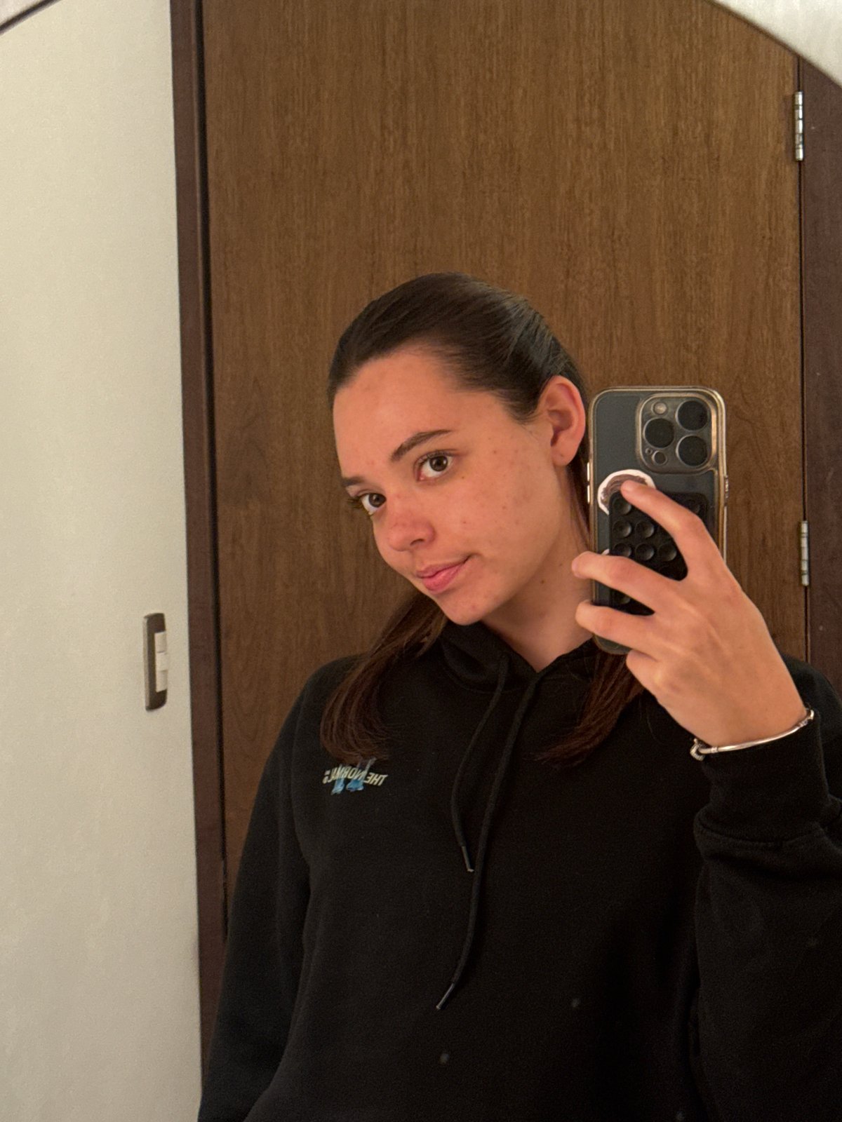 Woman takes mirror selfie in Mexican town early morning
