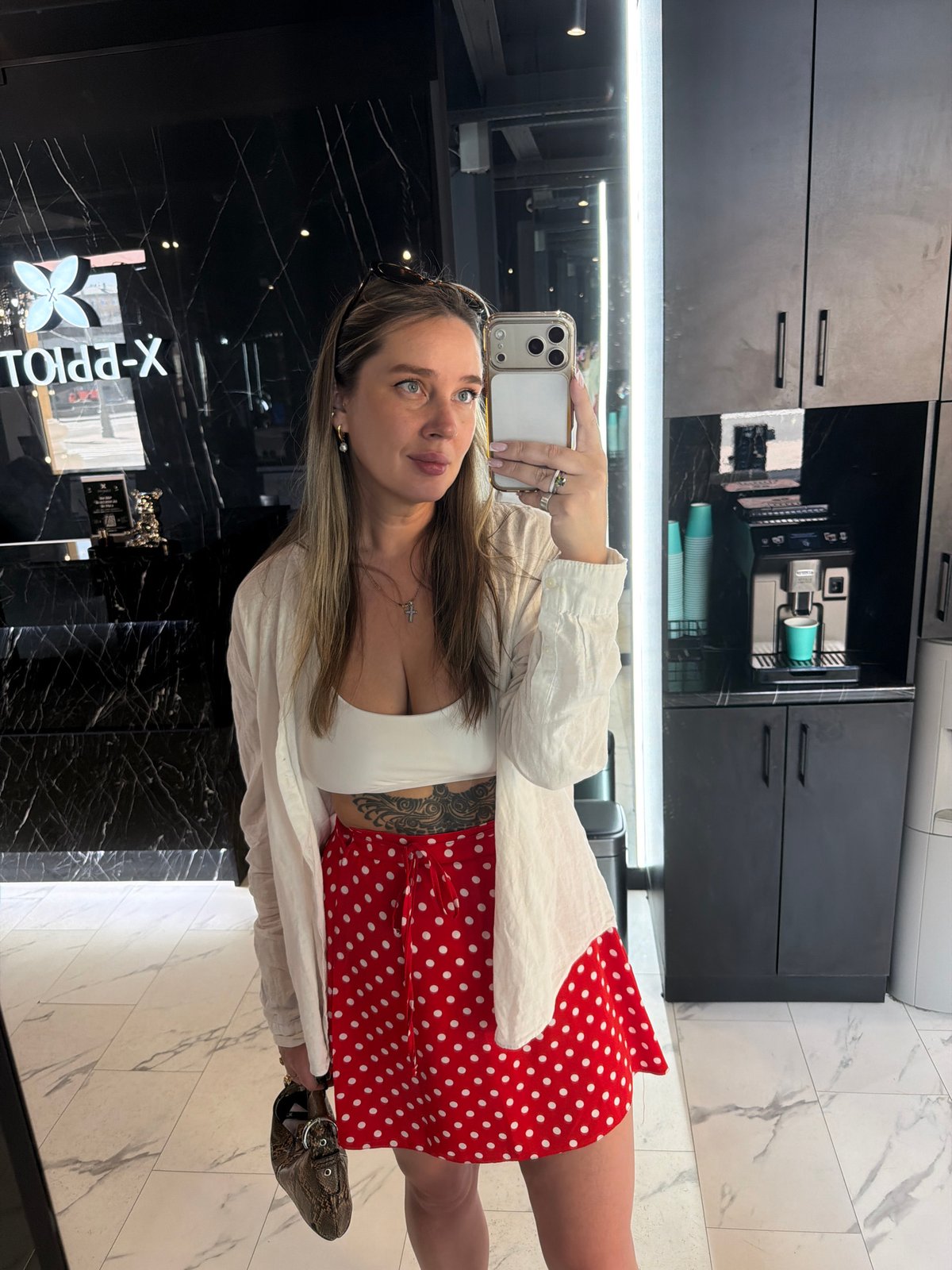 Woman takes selfie in Moscow salon wearing polka-dot outfit