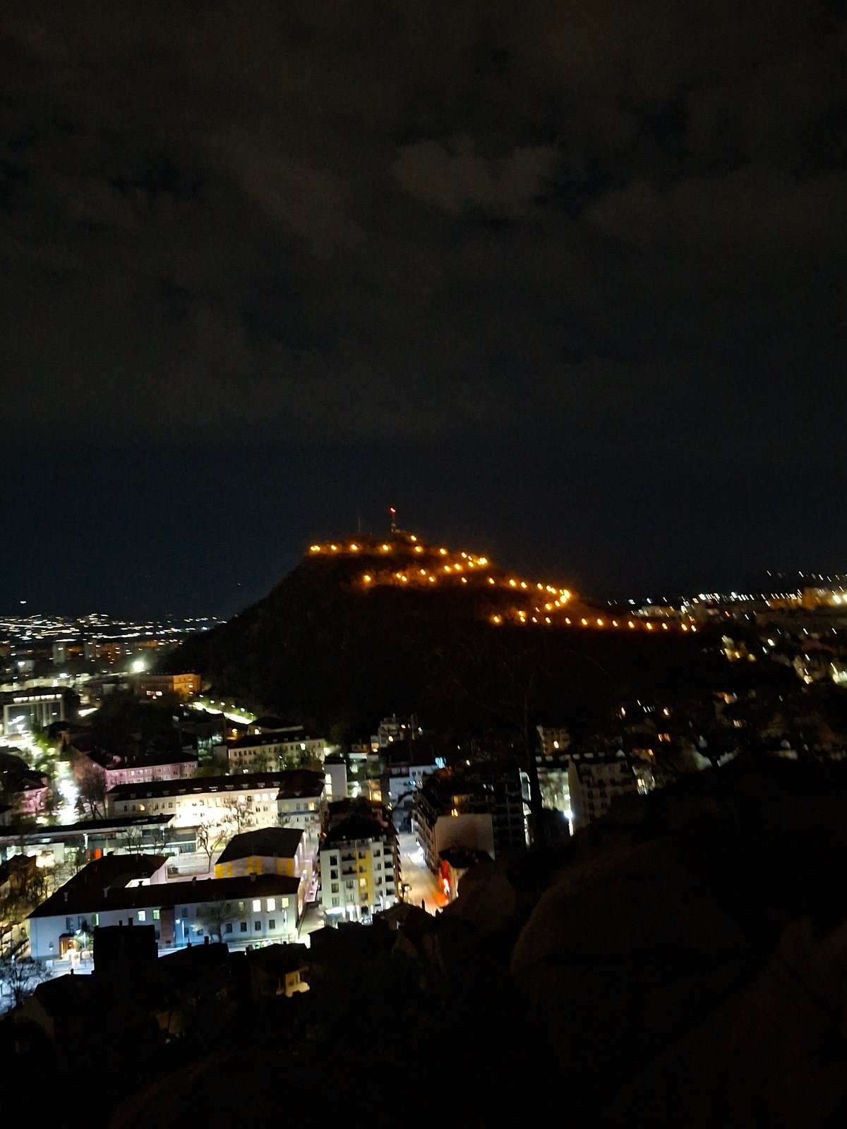 Plovdiv's illuminated hillside captured in nighttime cityscape view
