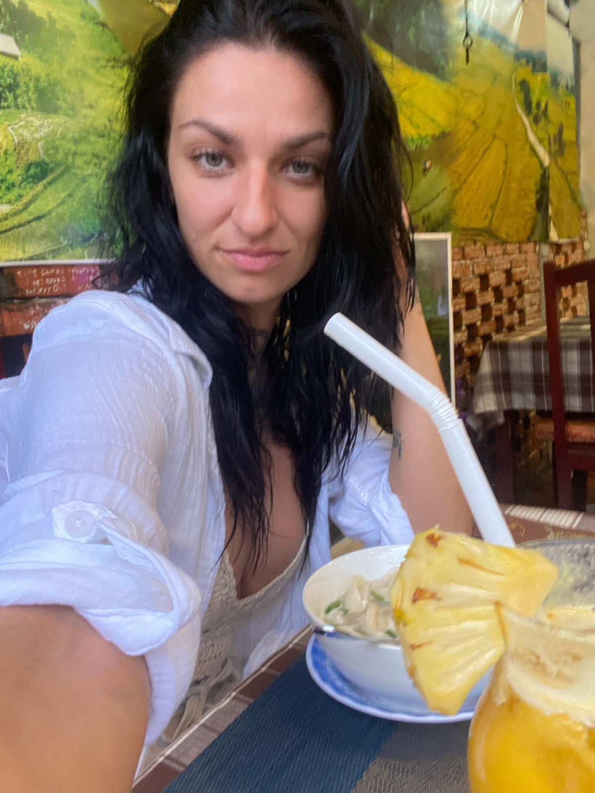 Two friends enjoy leisurely restaurant meal in Vietnam