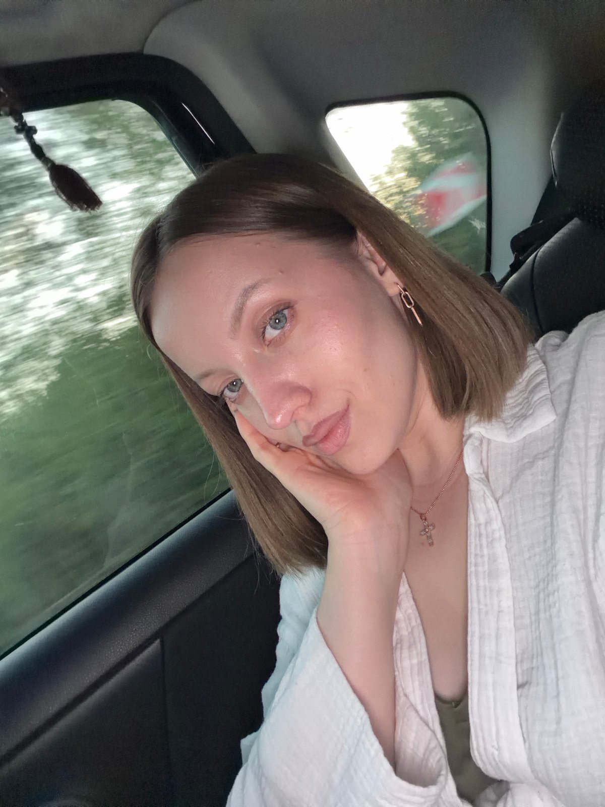 Woman takes selfie in car passenger seat in Russia
