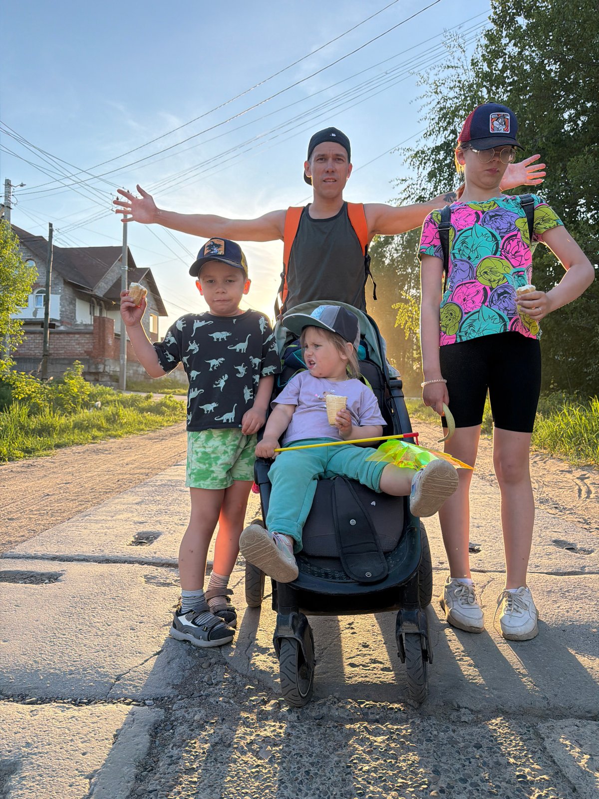 Family travels through Chaikovsky, Russia with stroller and children