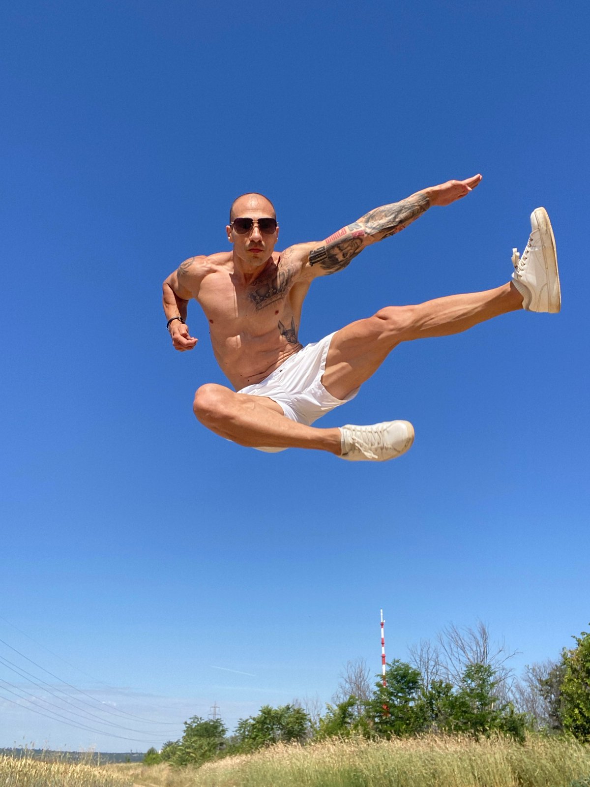 Tattooed acrobat mid-flip in Pleven, Bulgaria