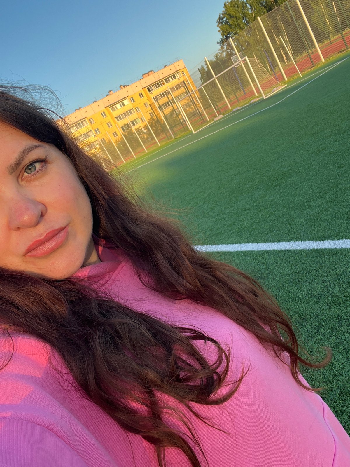 Afternoon hangout on a turf field in Noviy, Russia