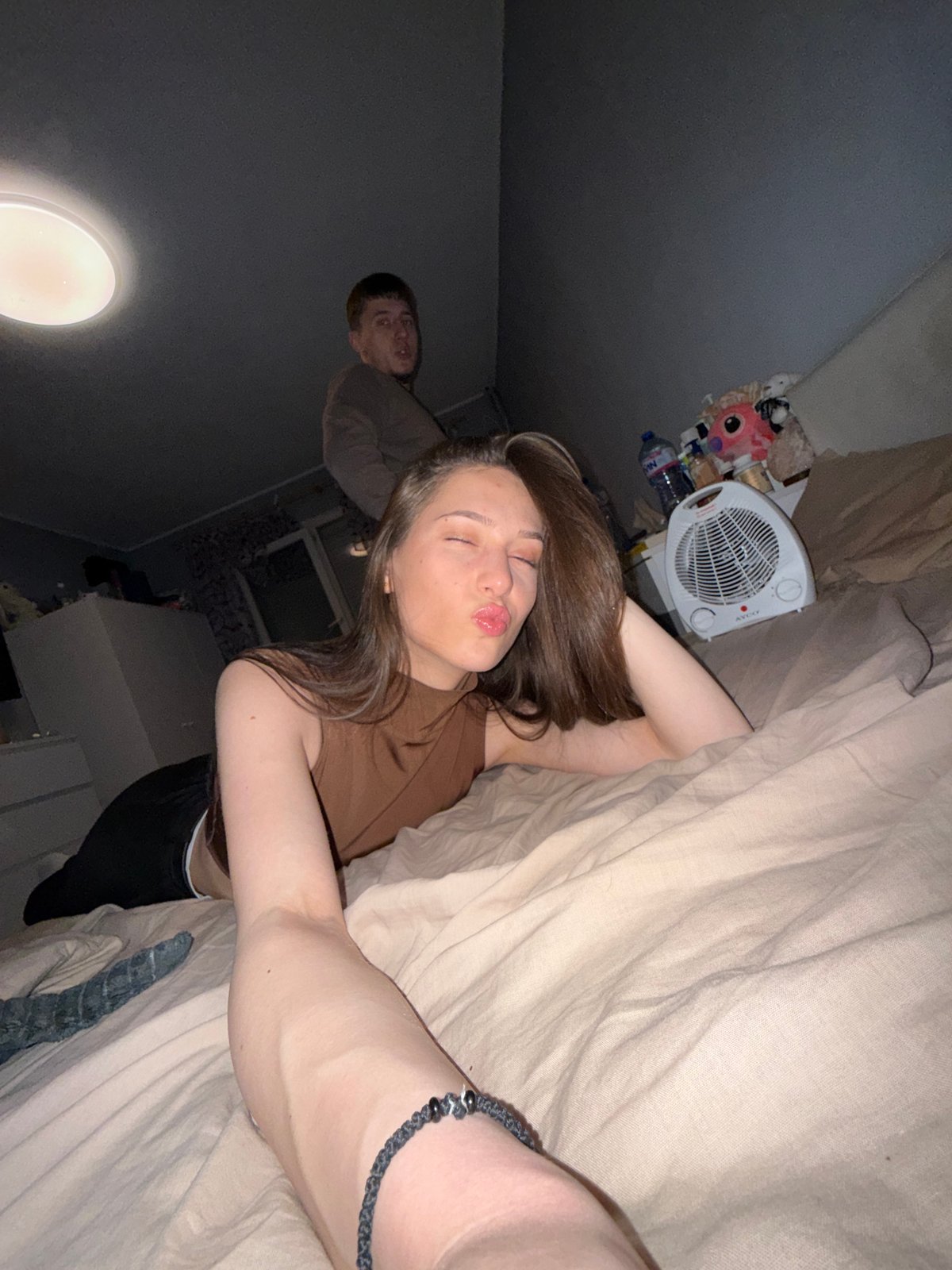 Young people gather in Sofia bedroom, smartphones present