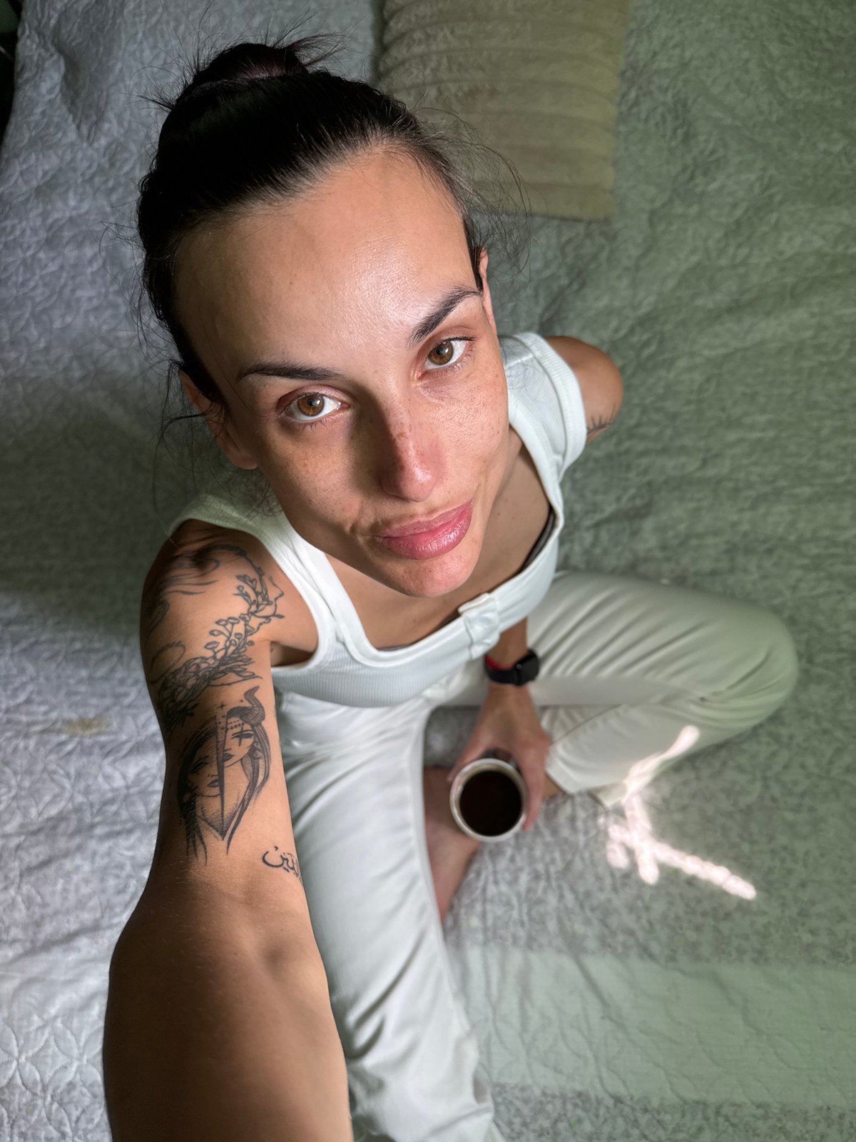 Woman photographed in casual morning moment on bed in Pleven
