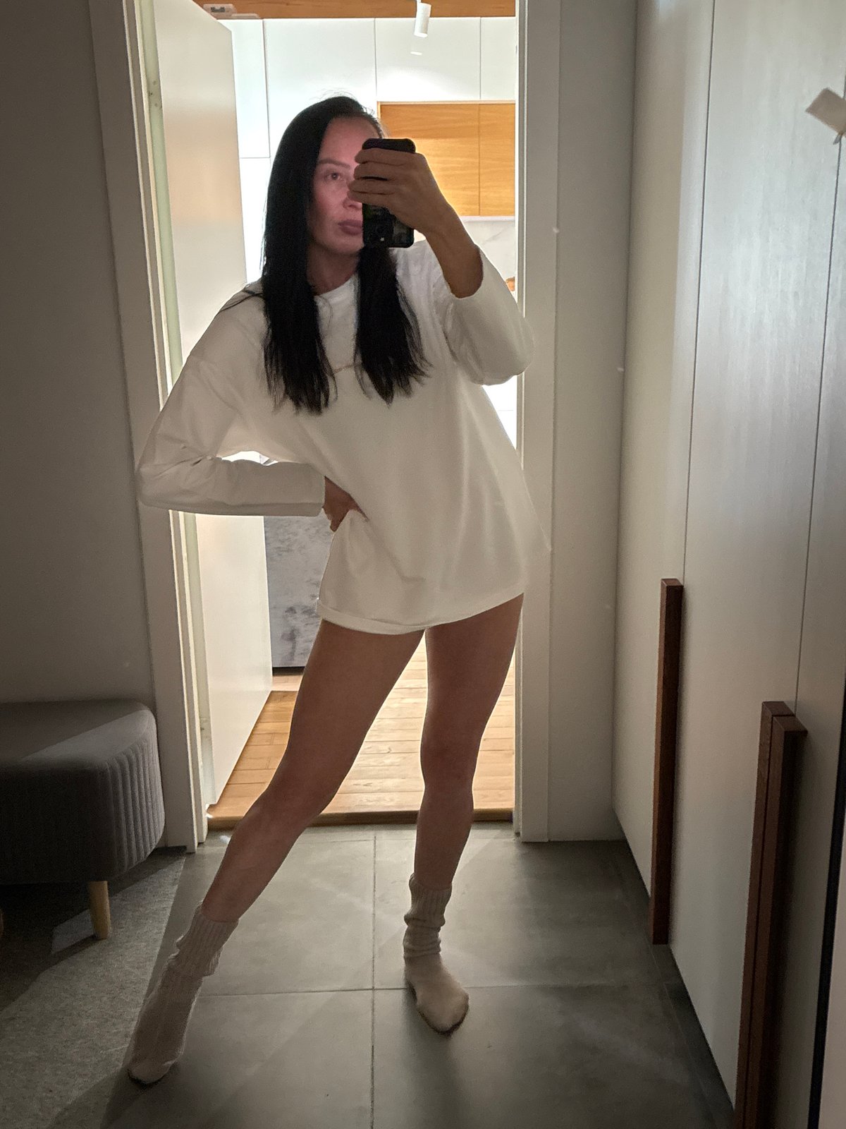 Woman takes bathroom mirror selfie in Chaikovsky, Russia