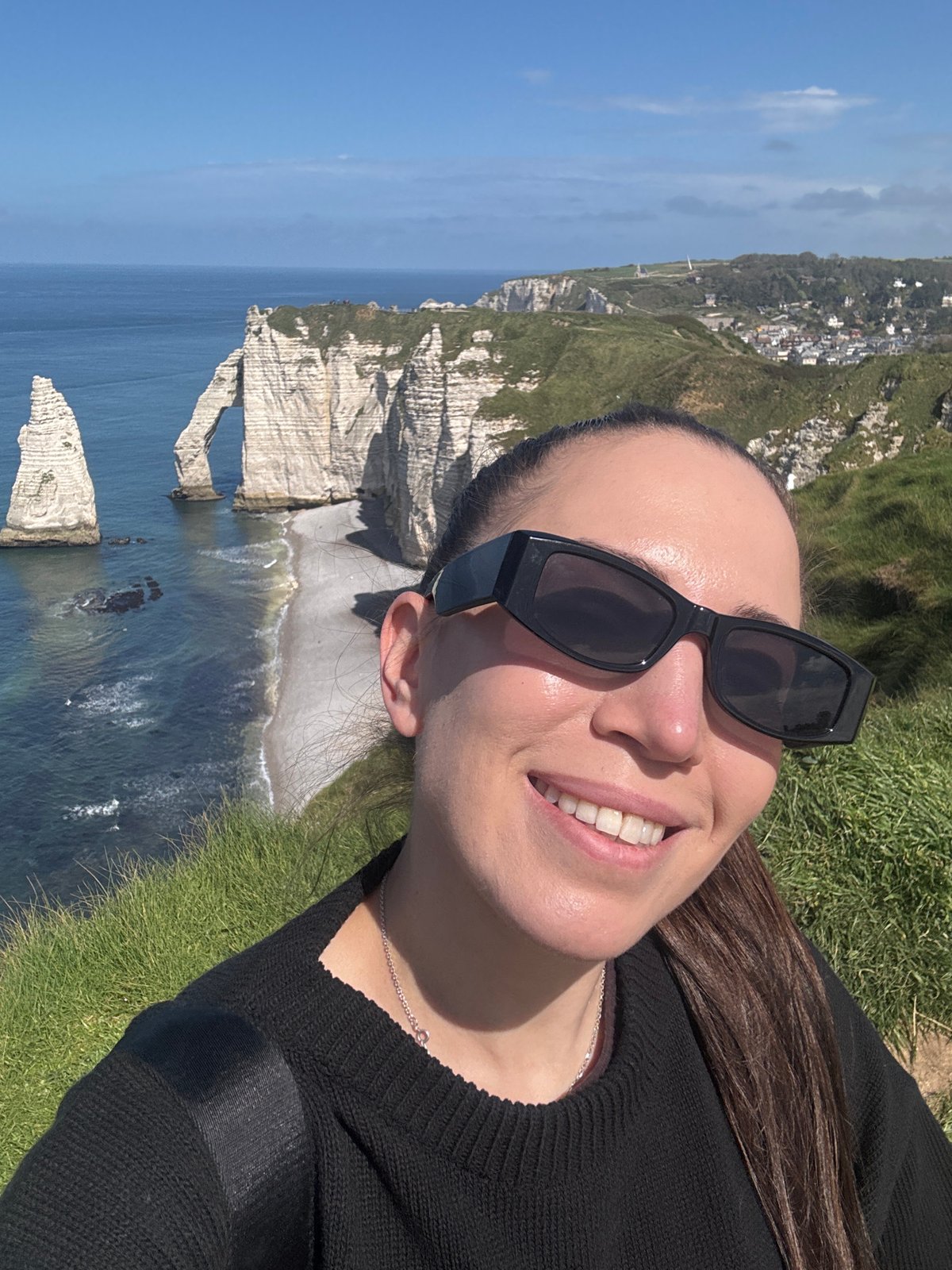 Tourists enjoy sunny day at Étretat's dramatic chalk cliffs