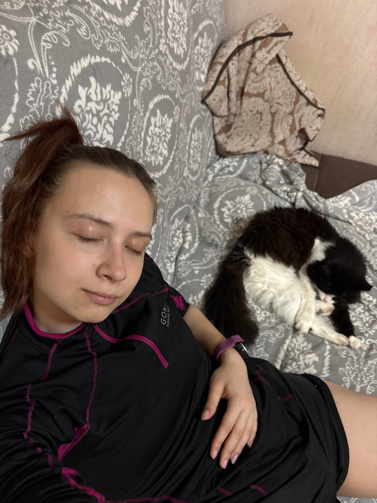 Woman and cat sleep peacefully in Russian home