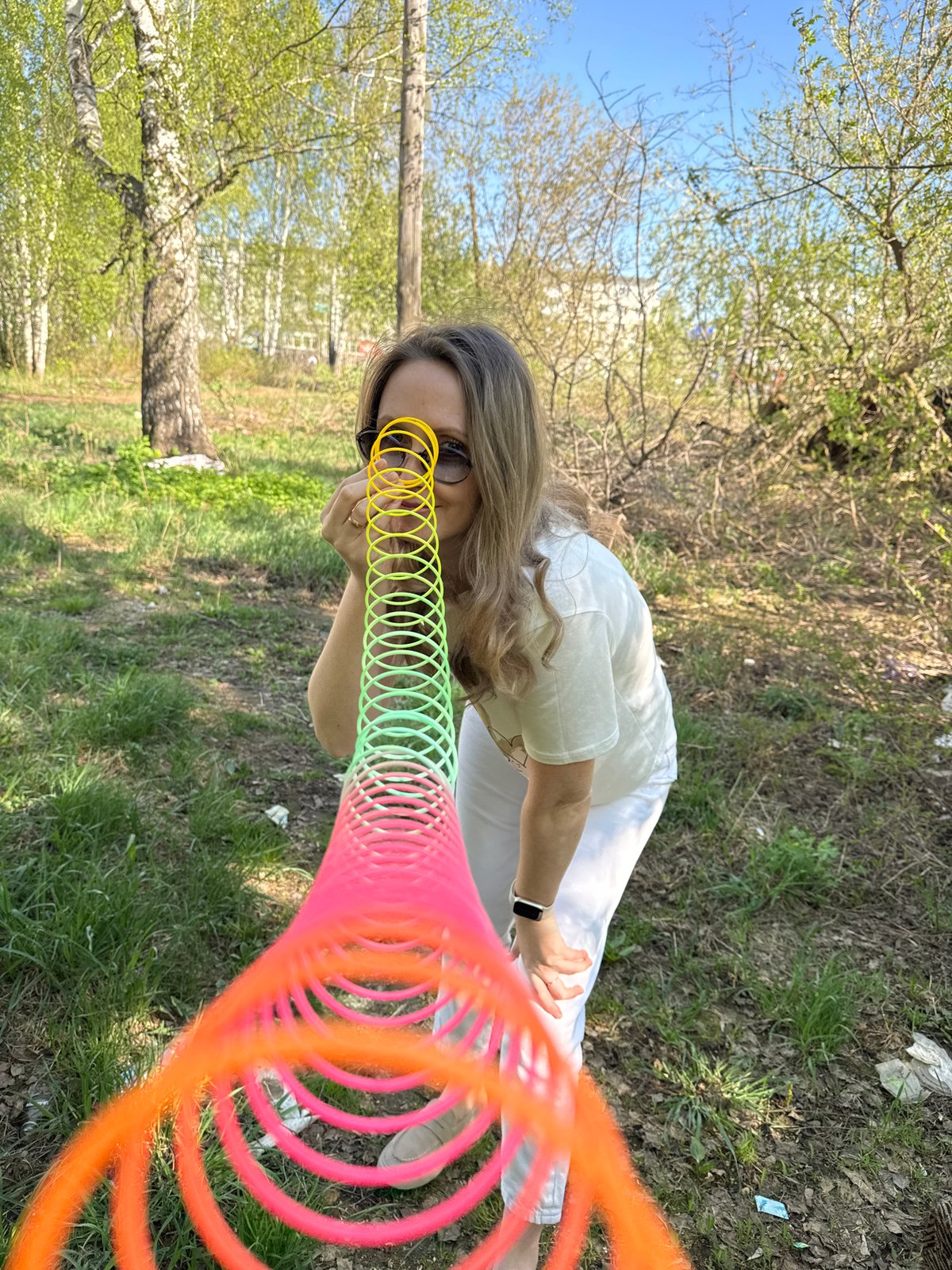 Woman enjoys spring afternoon with slinky in Chaikovsky park