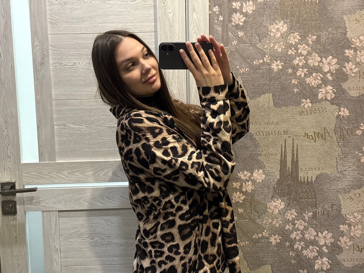 Woman takes selfies with Yekaterinburg city lights backdrop