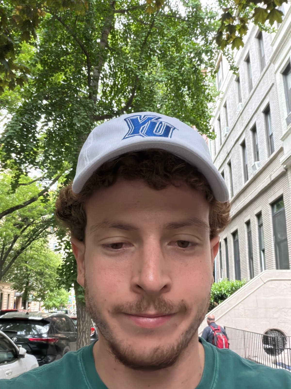 Man in baseball cap observed at NYC outdoor venue