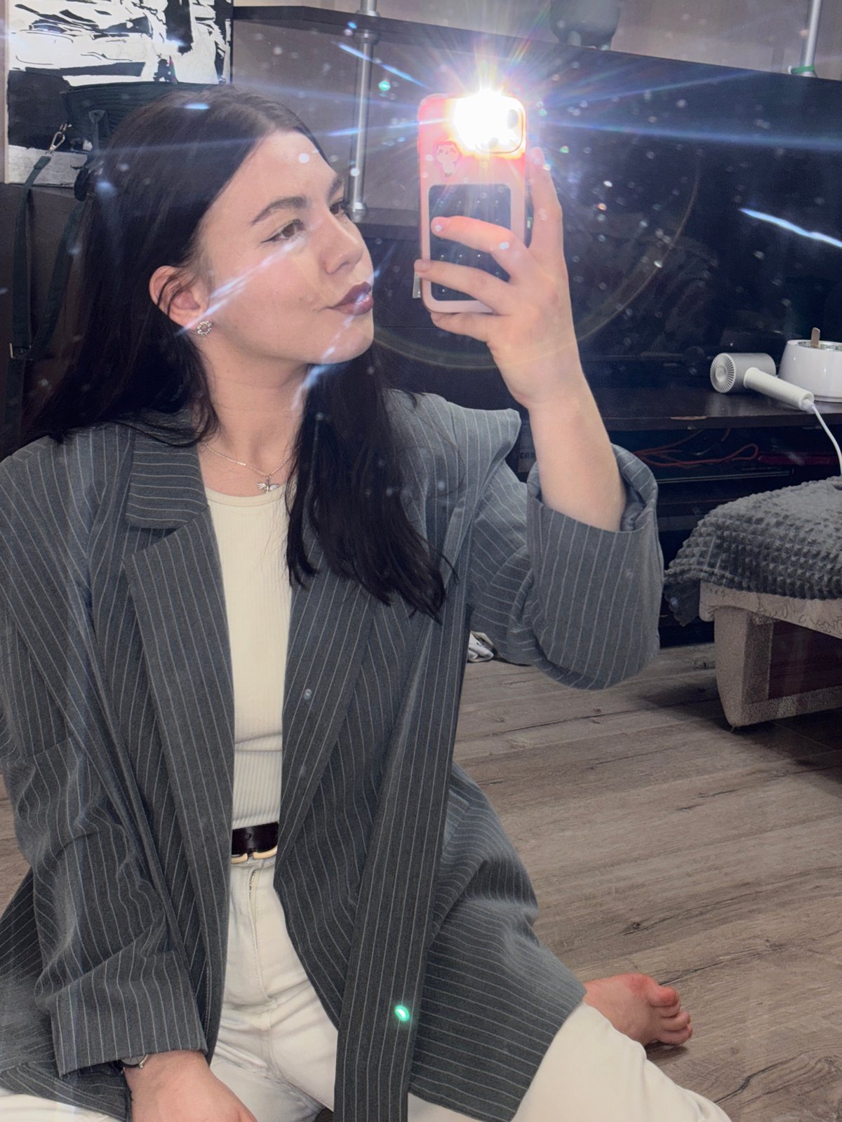 Woman takes mirror selfie in business attire in Perm