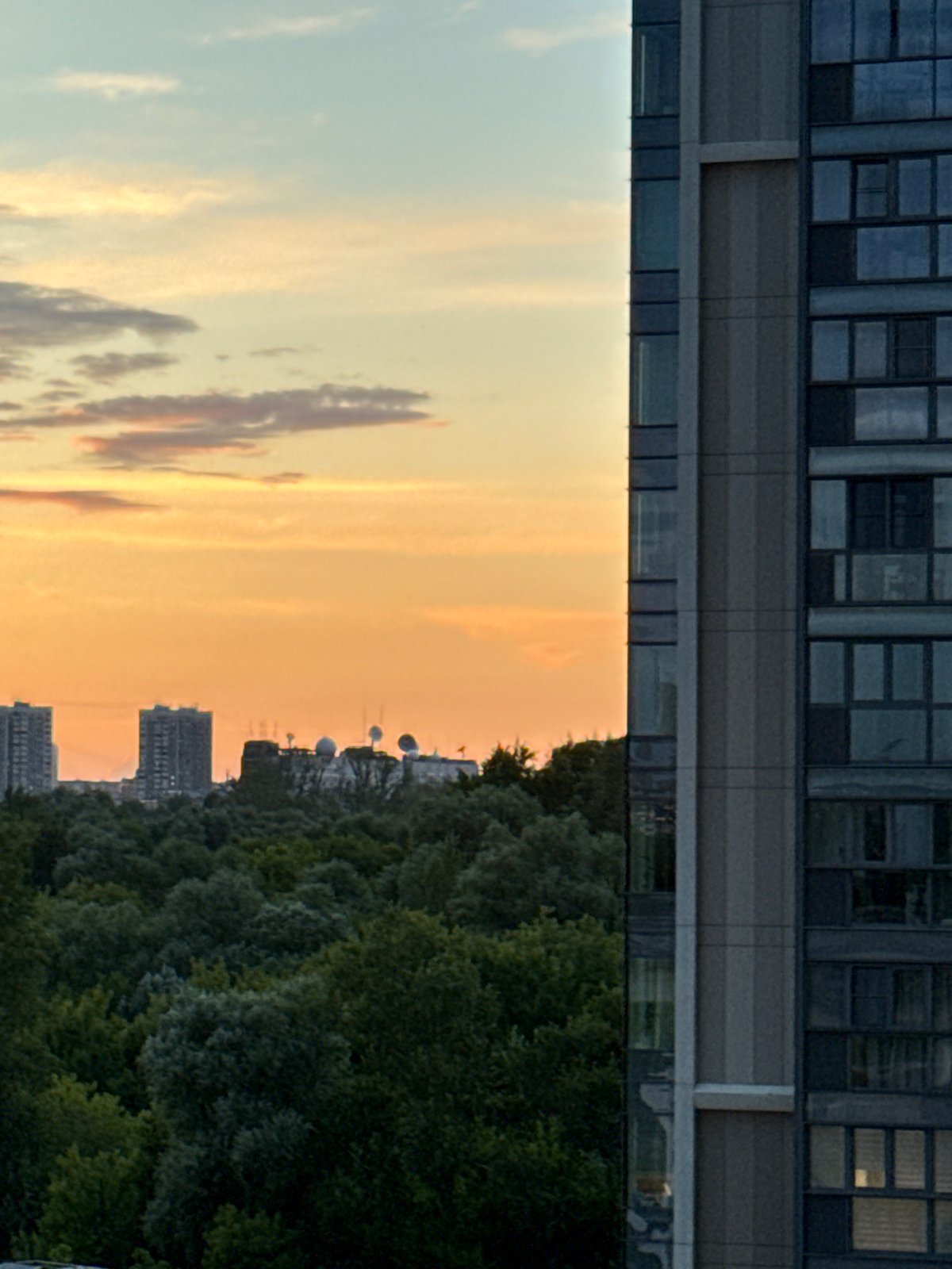 City skyline at golden hour, clouds and reflections