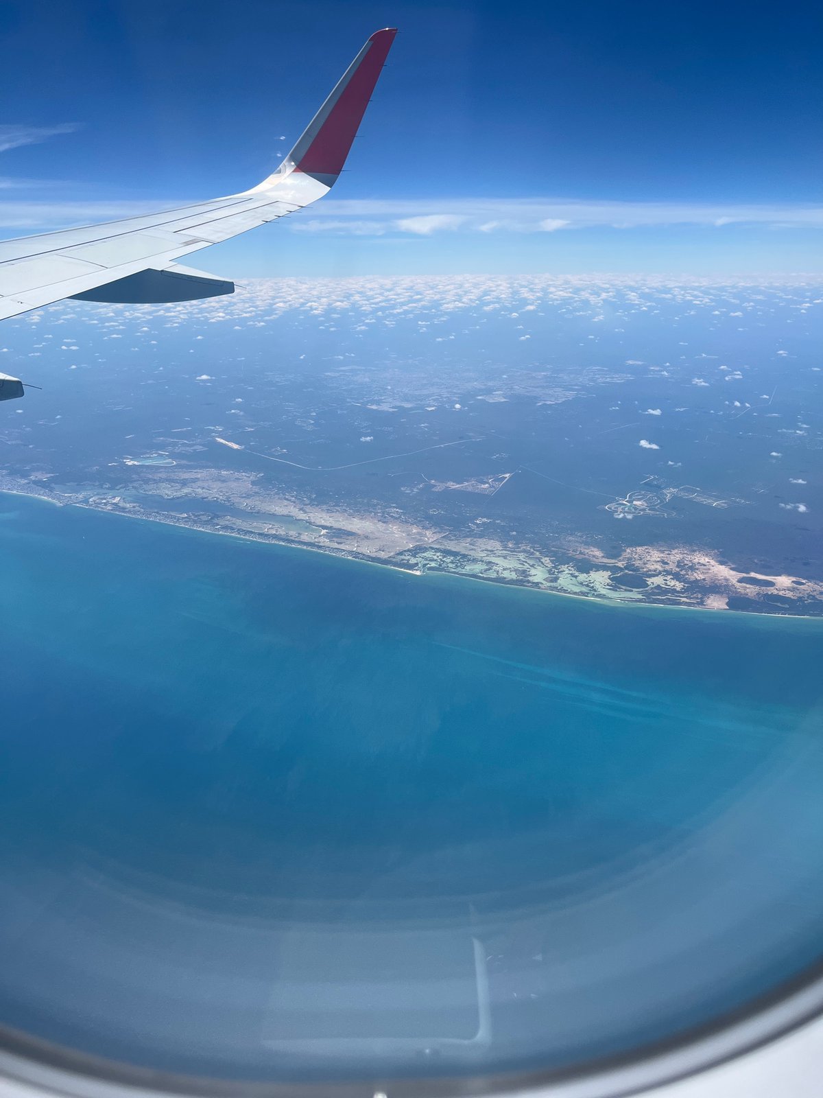 Aerial view of Puerto Arturo coastline captured from airplane