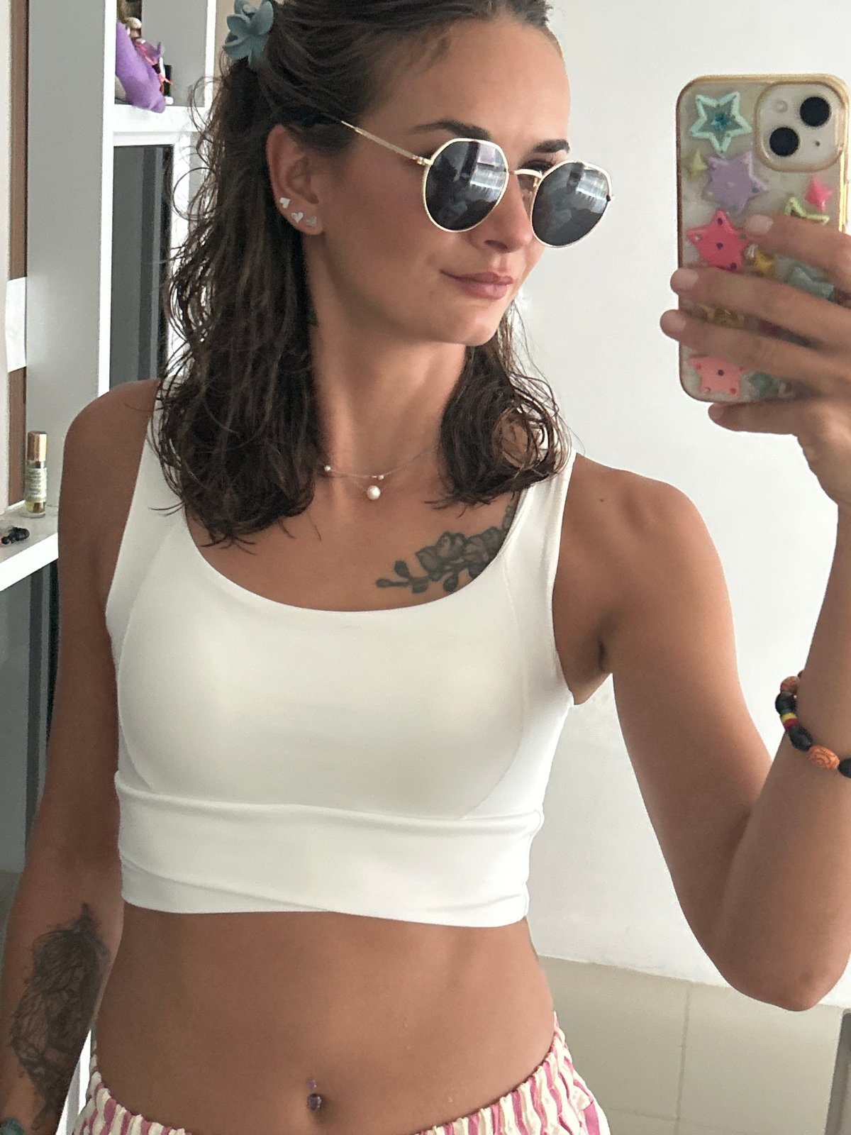 Woman takes mirror selfie indoors in Kathu, Thailand