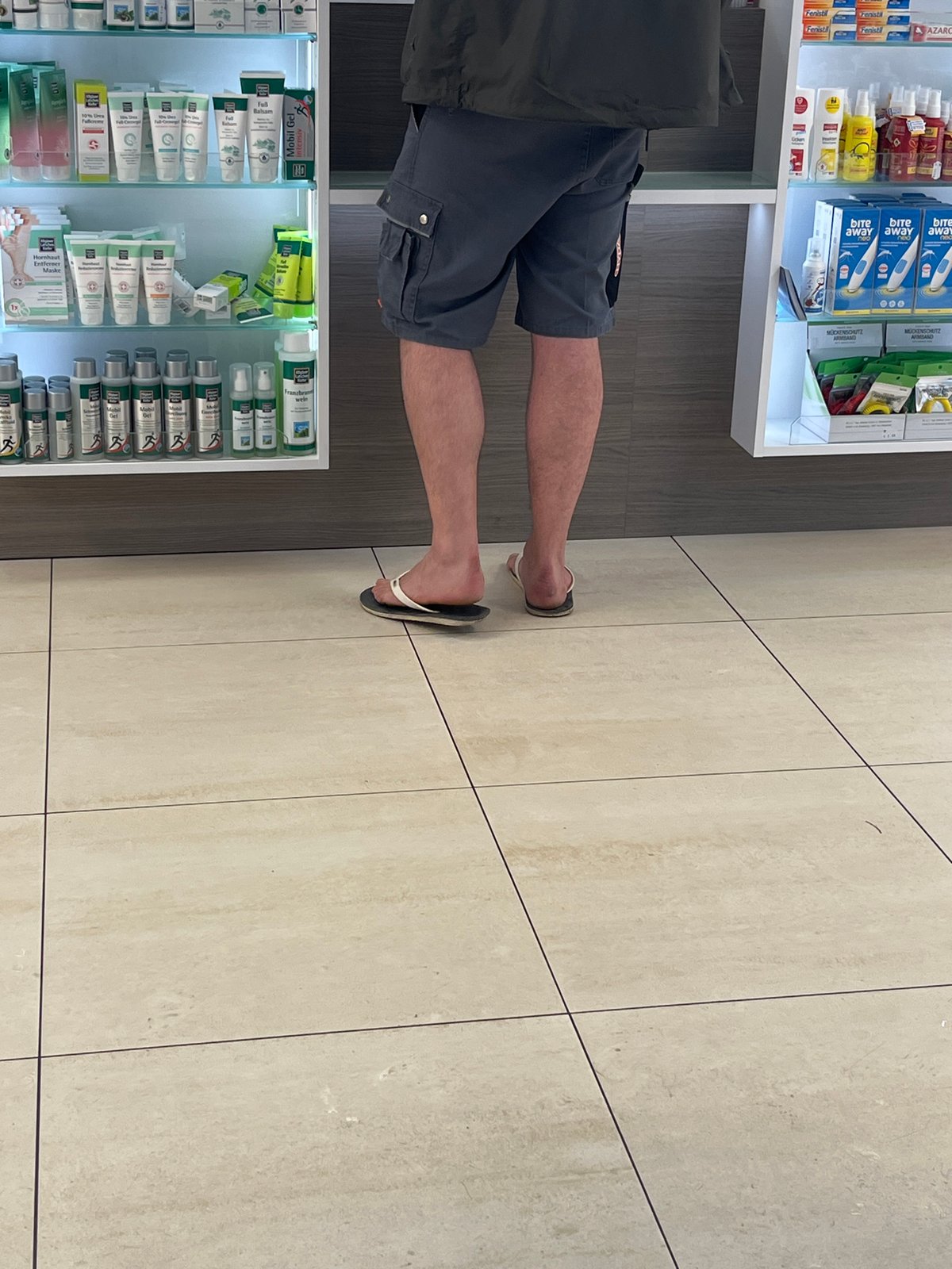 Person visits pharmacy in Saarbrücken wearing casual summer attire