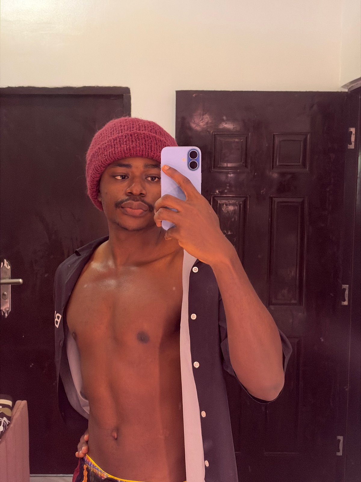 Man takes selfie with purple phone in Igboefon residence