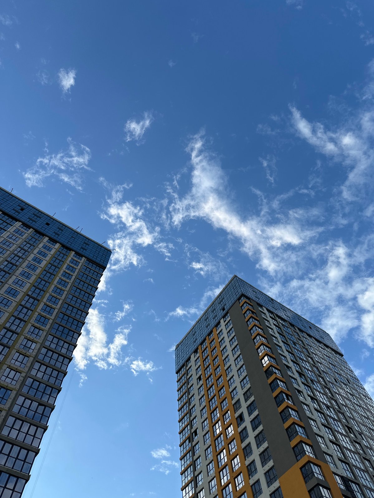 High-rise construction underway in Kyiv, cranes overhead