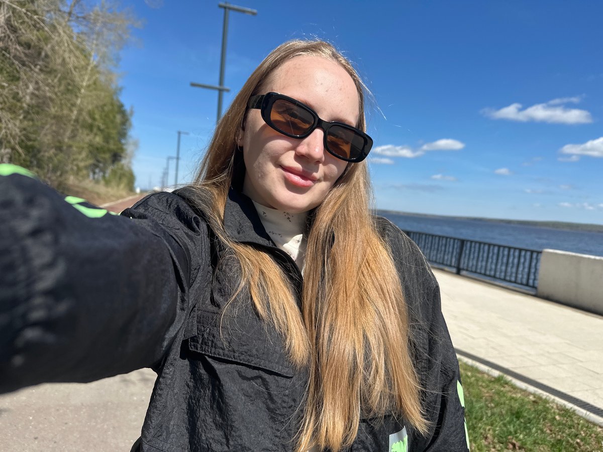 Woman photographed at Chaikovsky waterfront promenade on clear morning