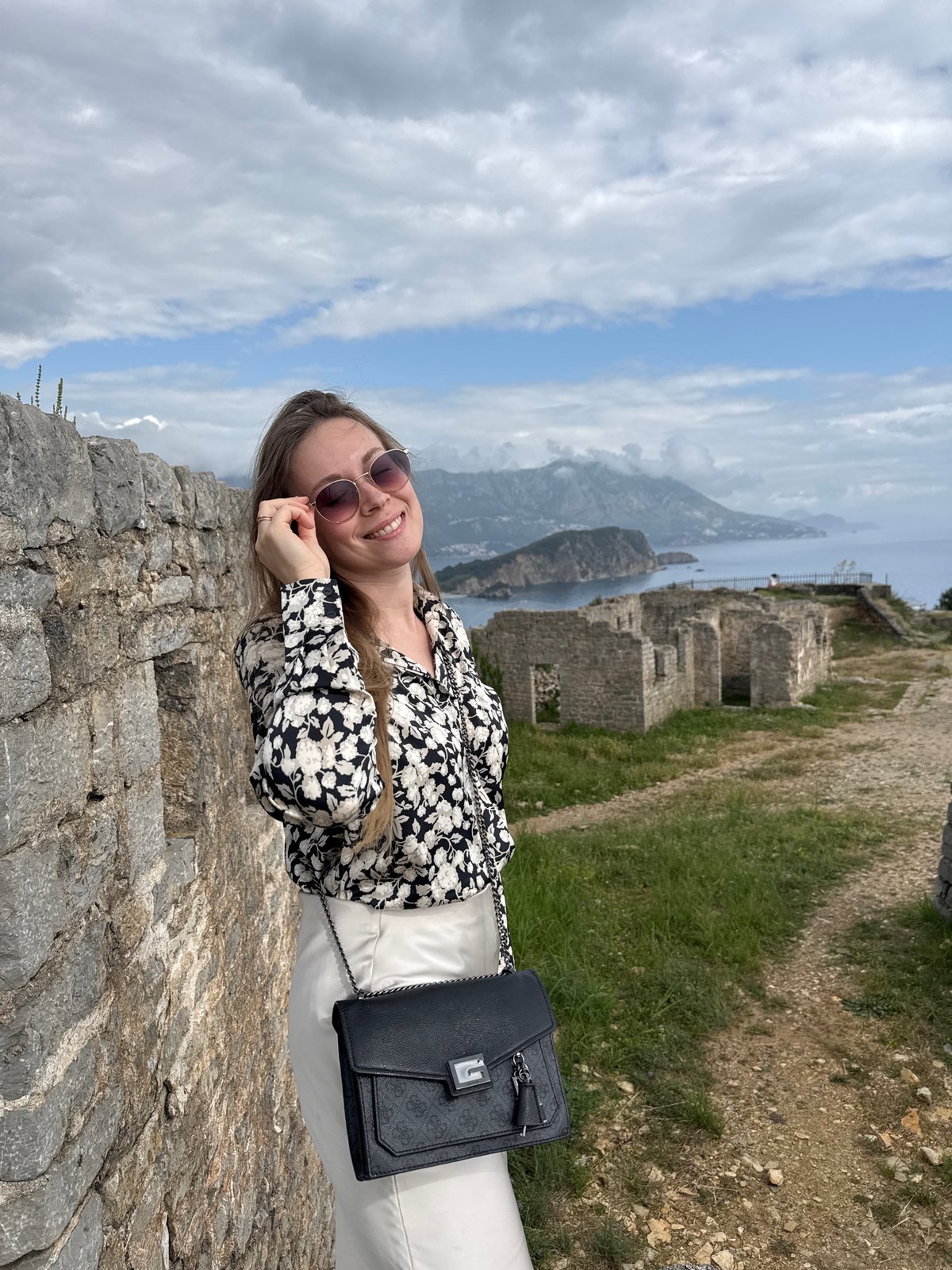 Tourists visit Budva's Old Fortress on cloudy afternoon