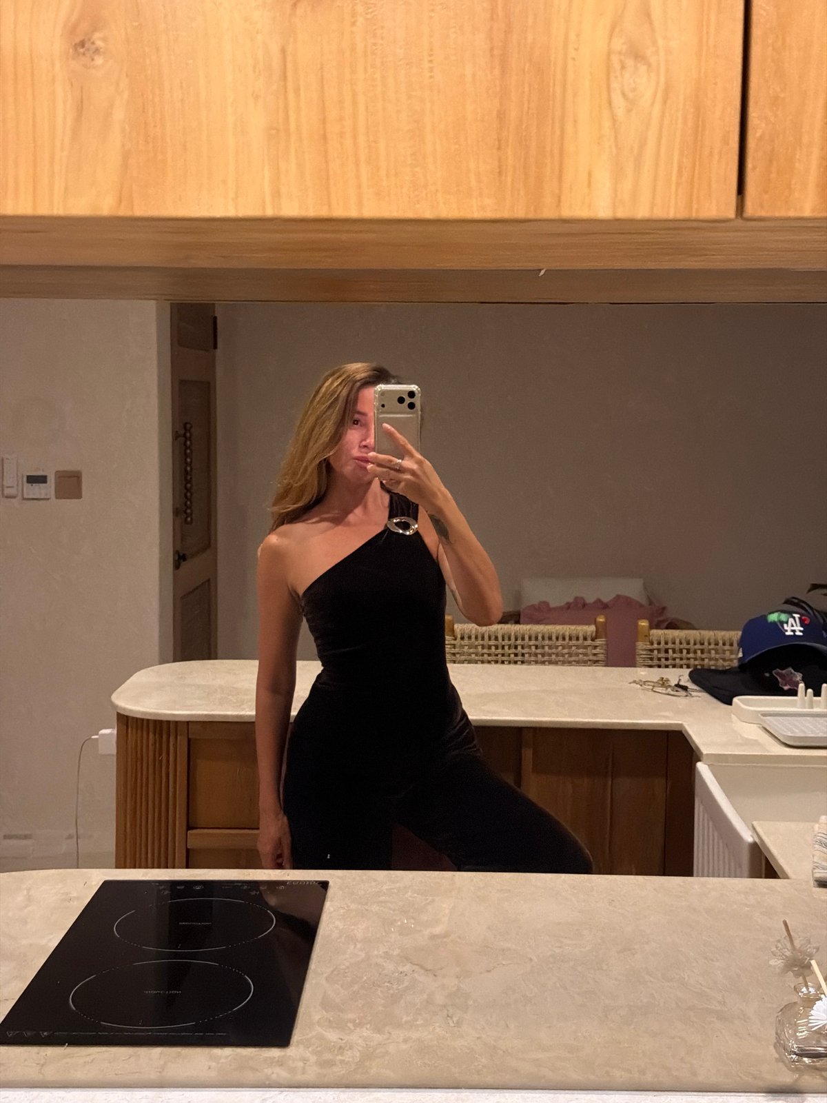 Mirror selfies in a modern Mengwi bathroom, black dress and LED light.