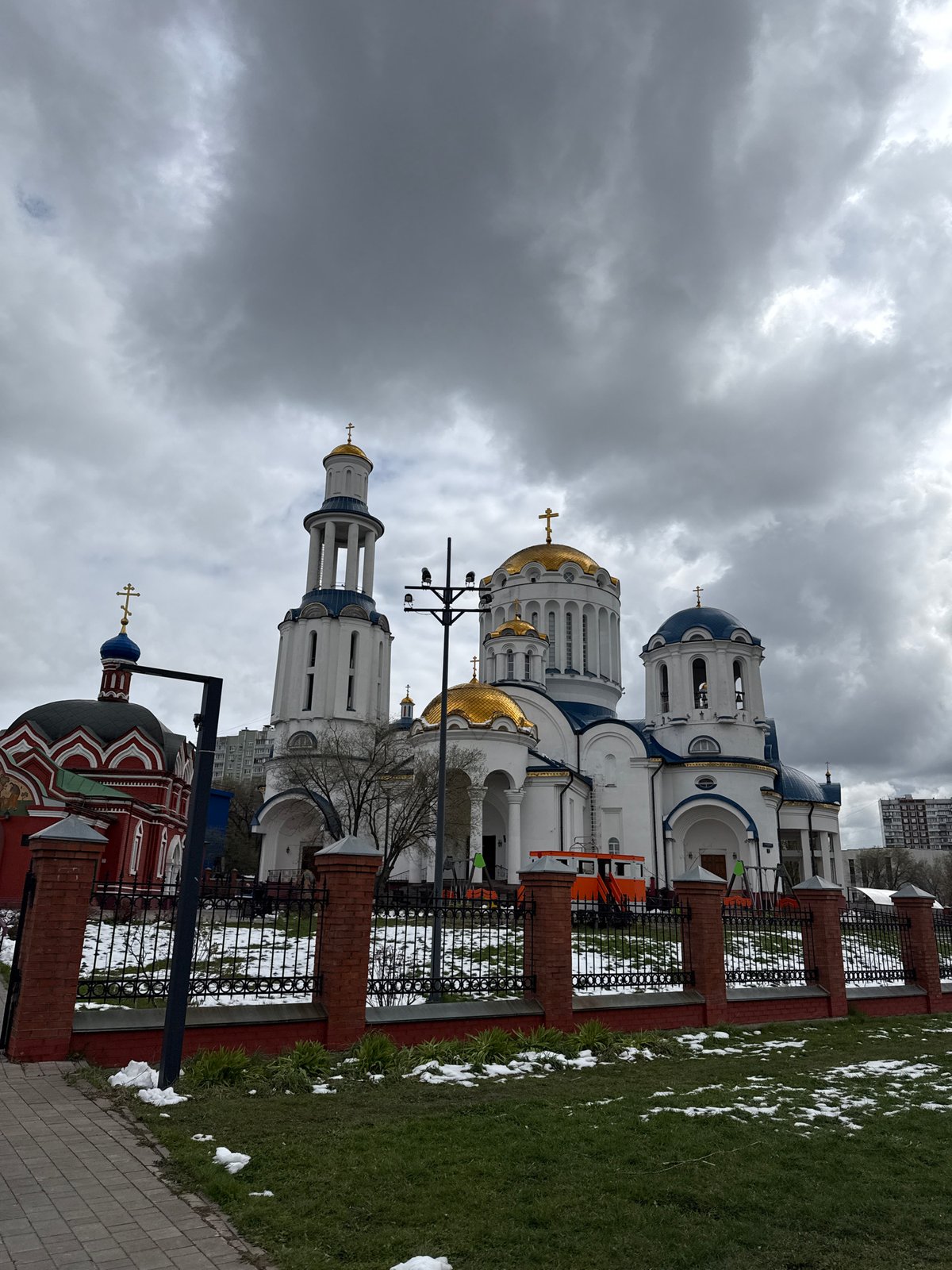 Orthodox churches with onion domes observed under gray Moscow sky