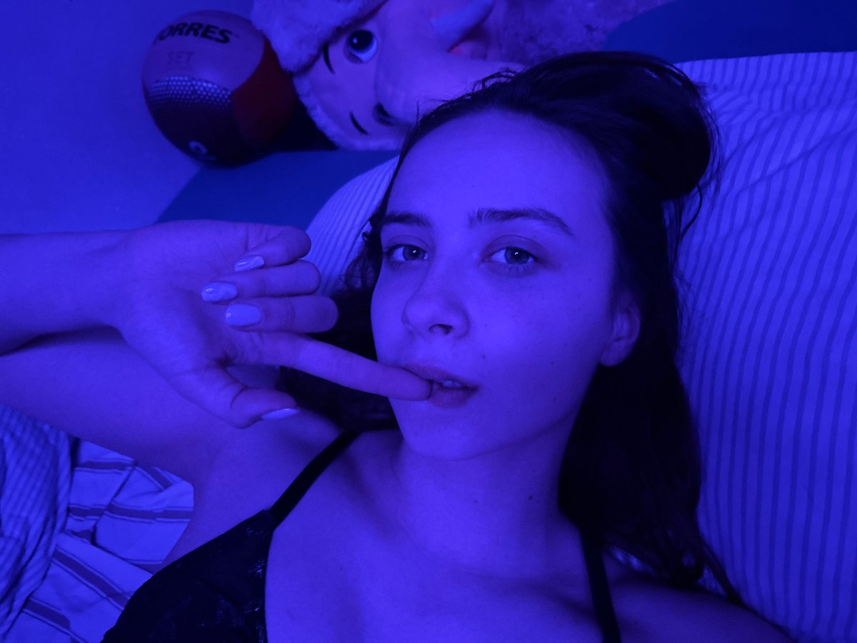 Woman photographed indoors under blue lighting in Prikamsky, Russia