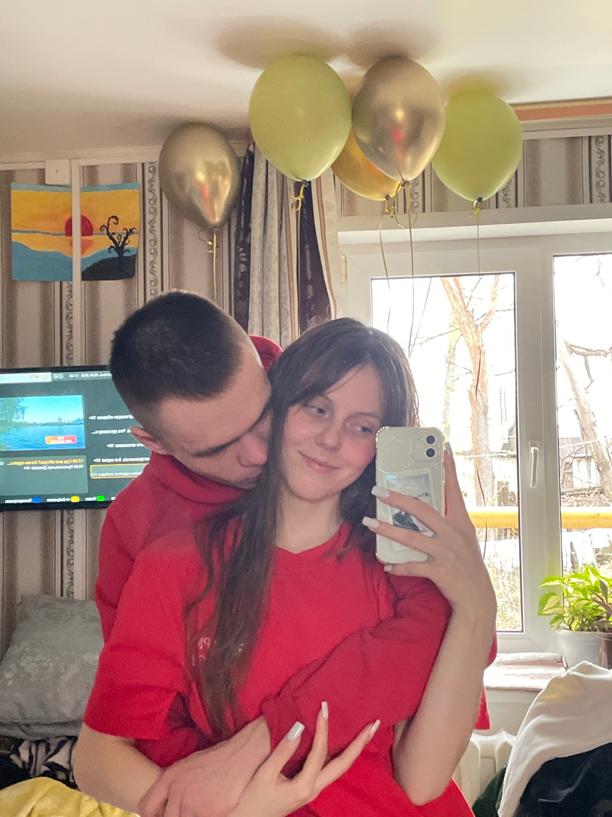 Couple documents indoor celebration with selfies and balloons in Russia