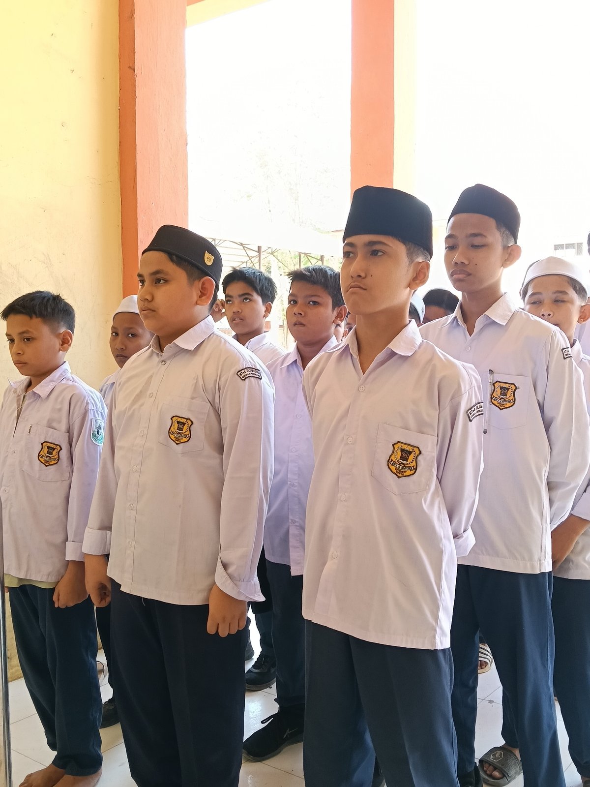 Morning scenes in Lhokseumawe: students in formation, vintage motorcycle