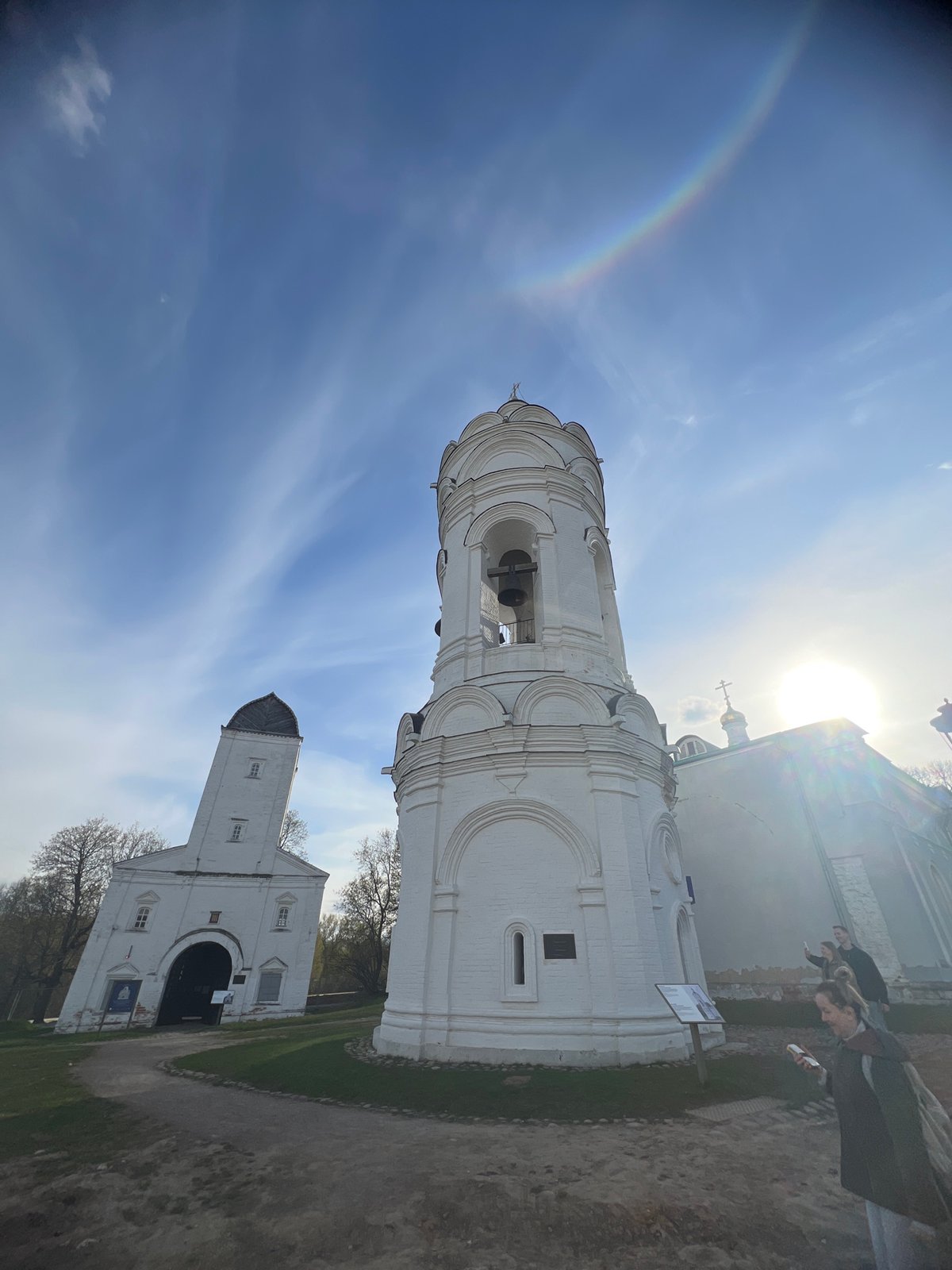 Rainbow arches over Moscow's historic Kolomenskoye Church during sunny afternoon