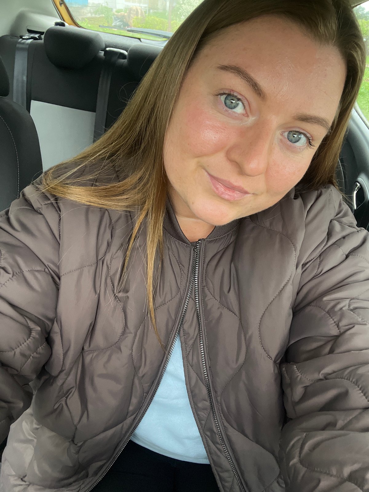 Woman takes selfie in car in Razdolye, Russia