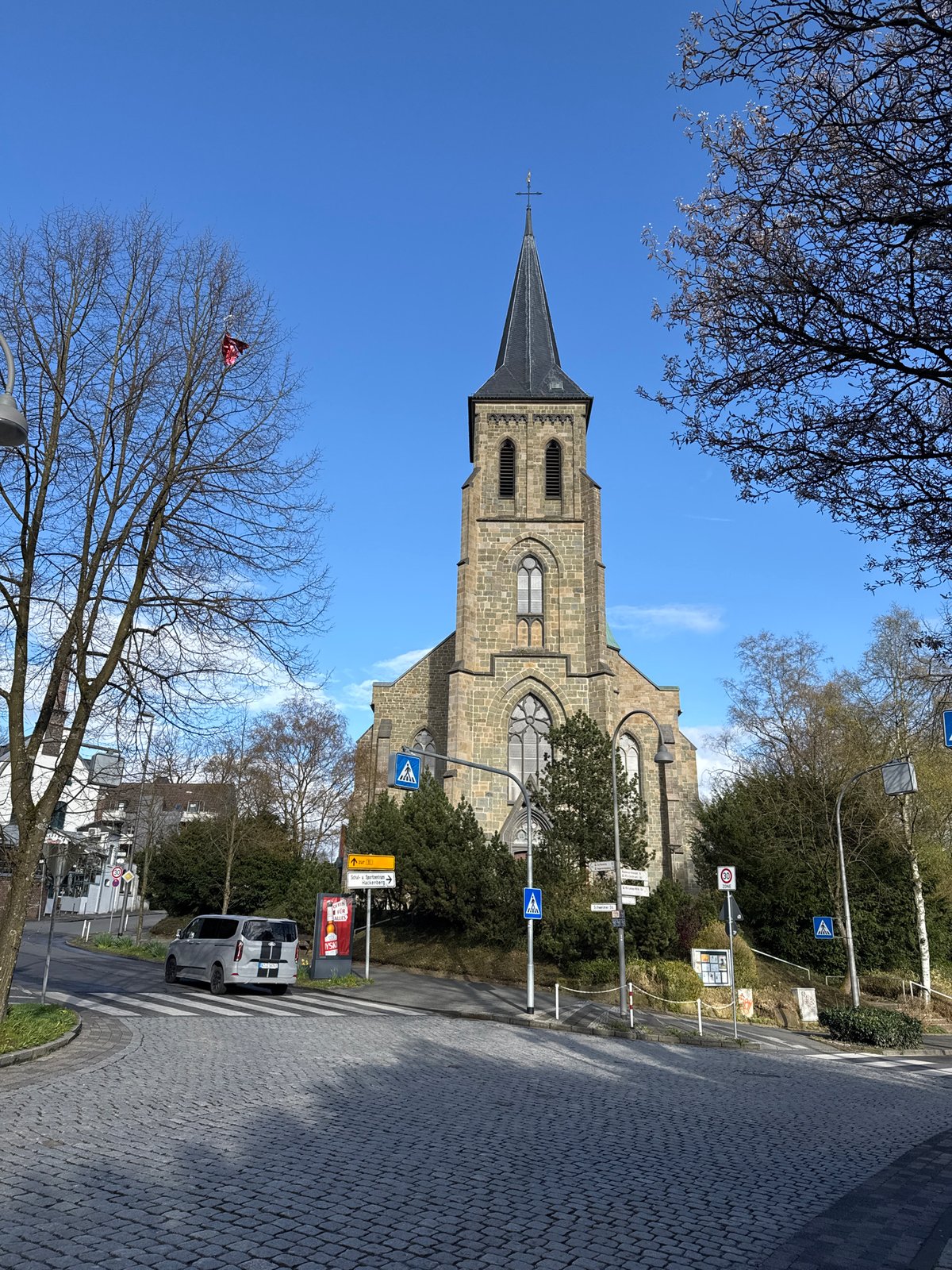 Tourist documents historic Remscheid architecture and landmarks during afternoon stroll