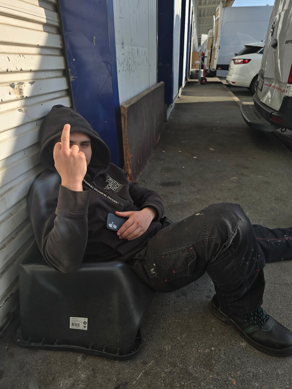 Person resting on container near vans in Kabelsketal