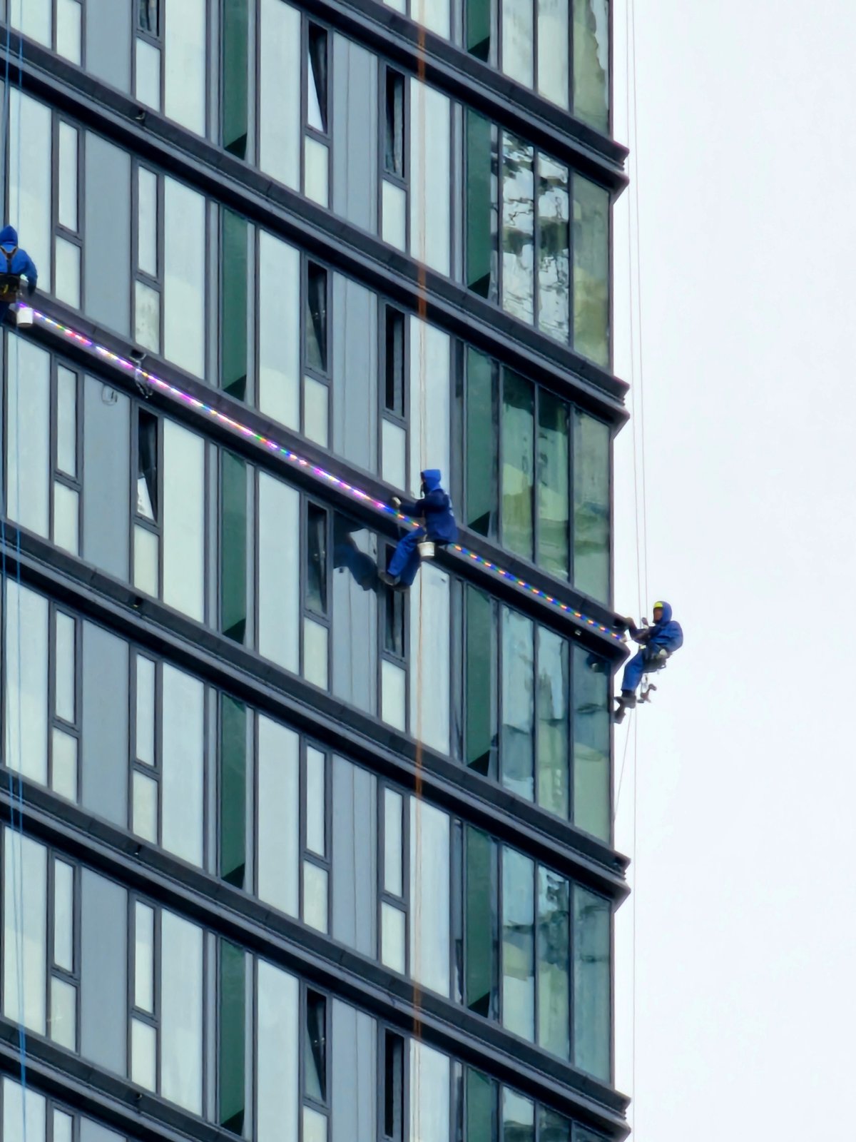 Window cleaning crew works high-rise glass facade in Moscow
