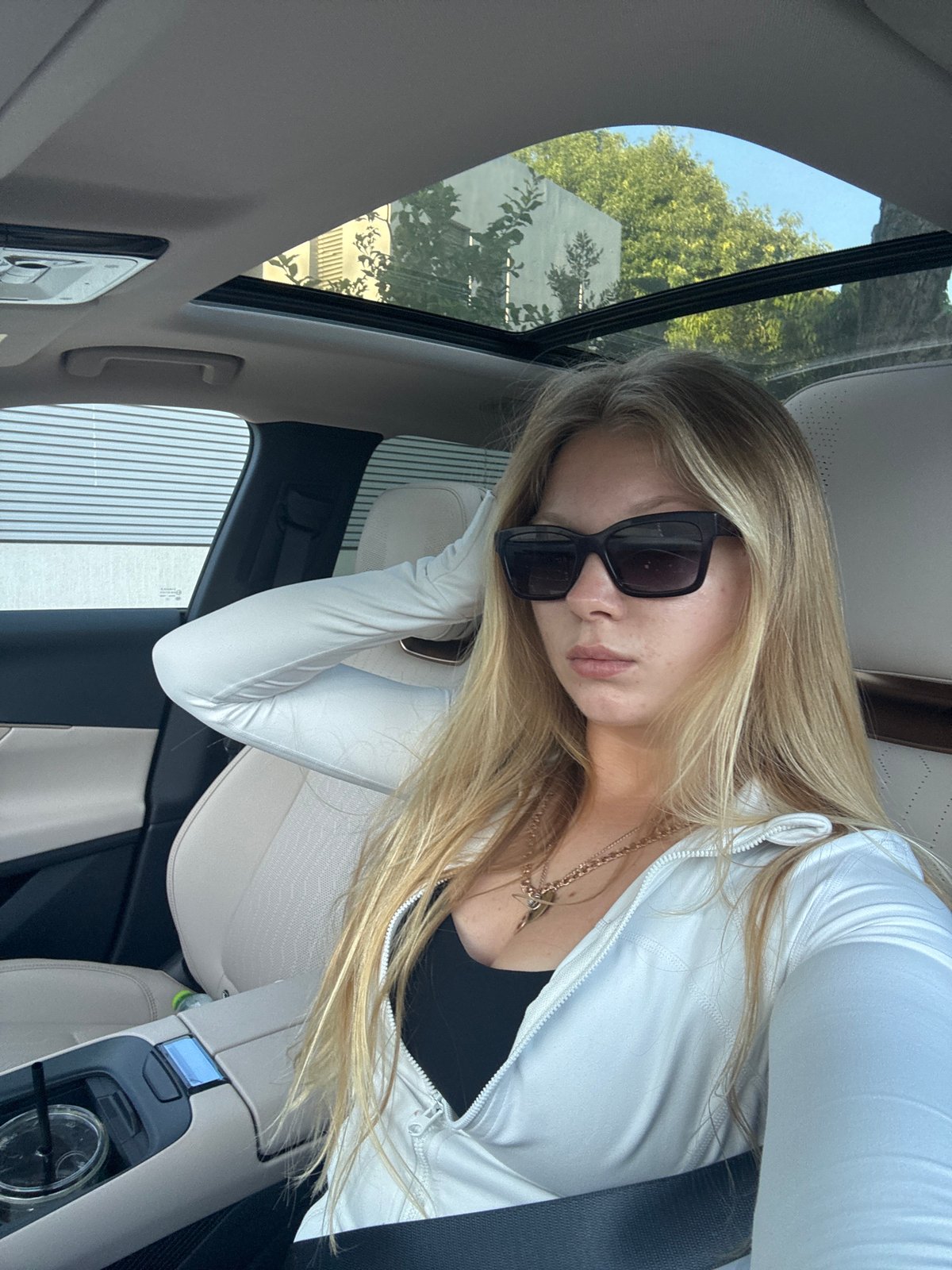 Woman photographed in car passenger seat in Kfar Shmaryahu