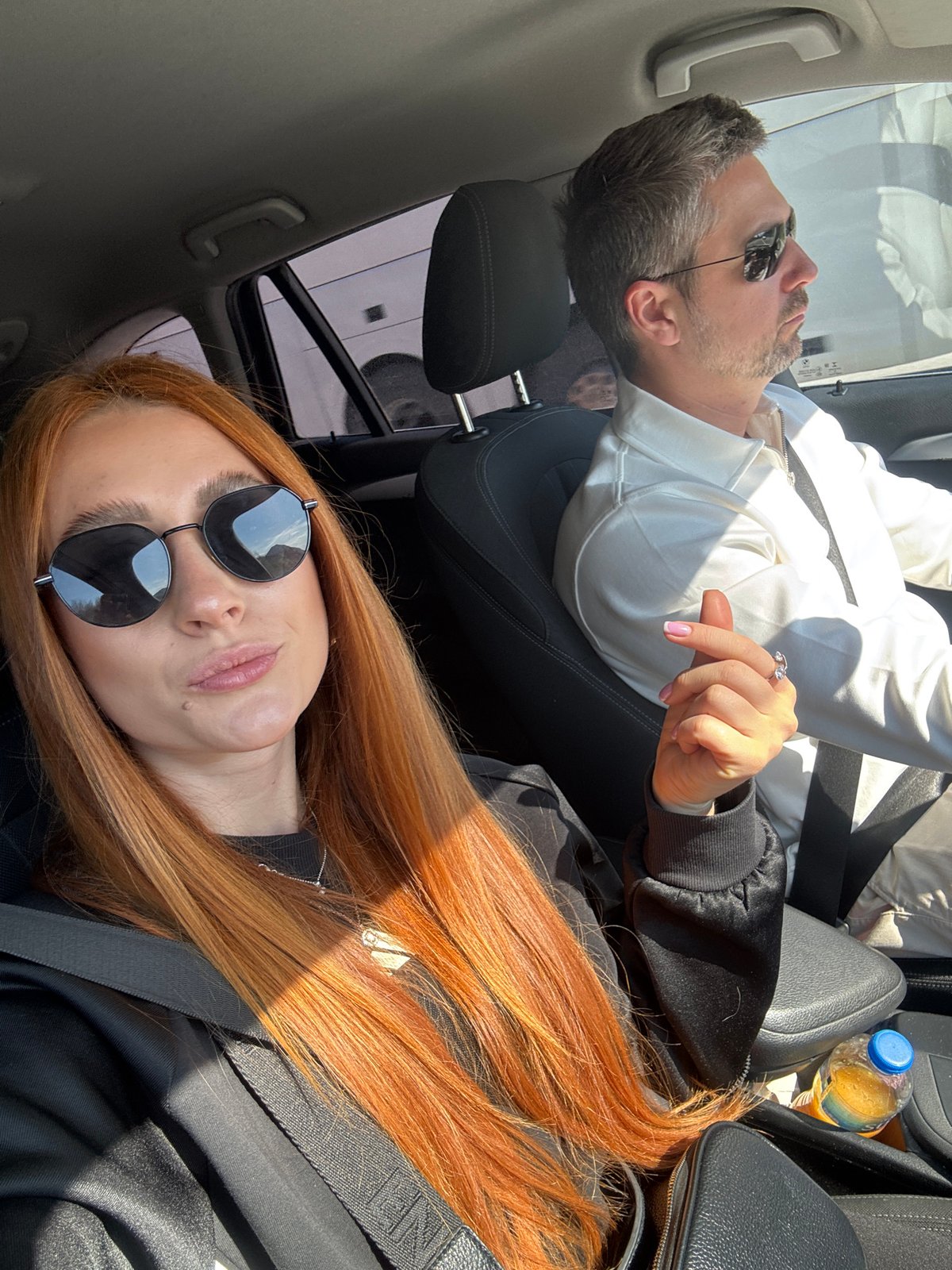 Two people photographed in car in Mišići, Montenegro