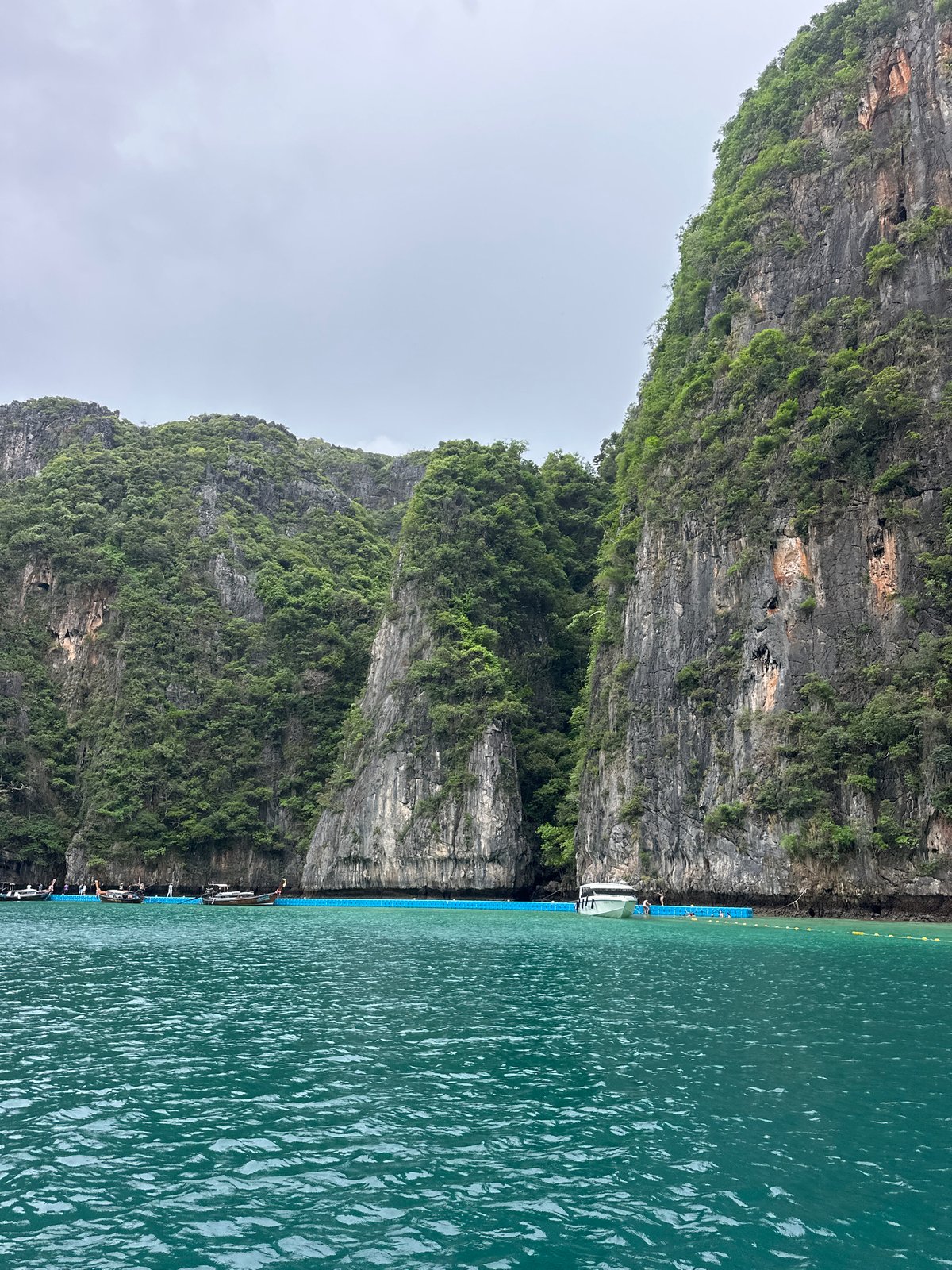 Dawn boat tours navigate Ao Nang's limestone cliffs