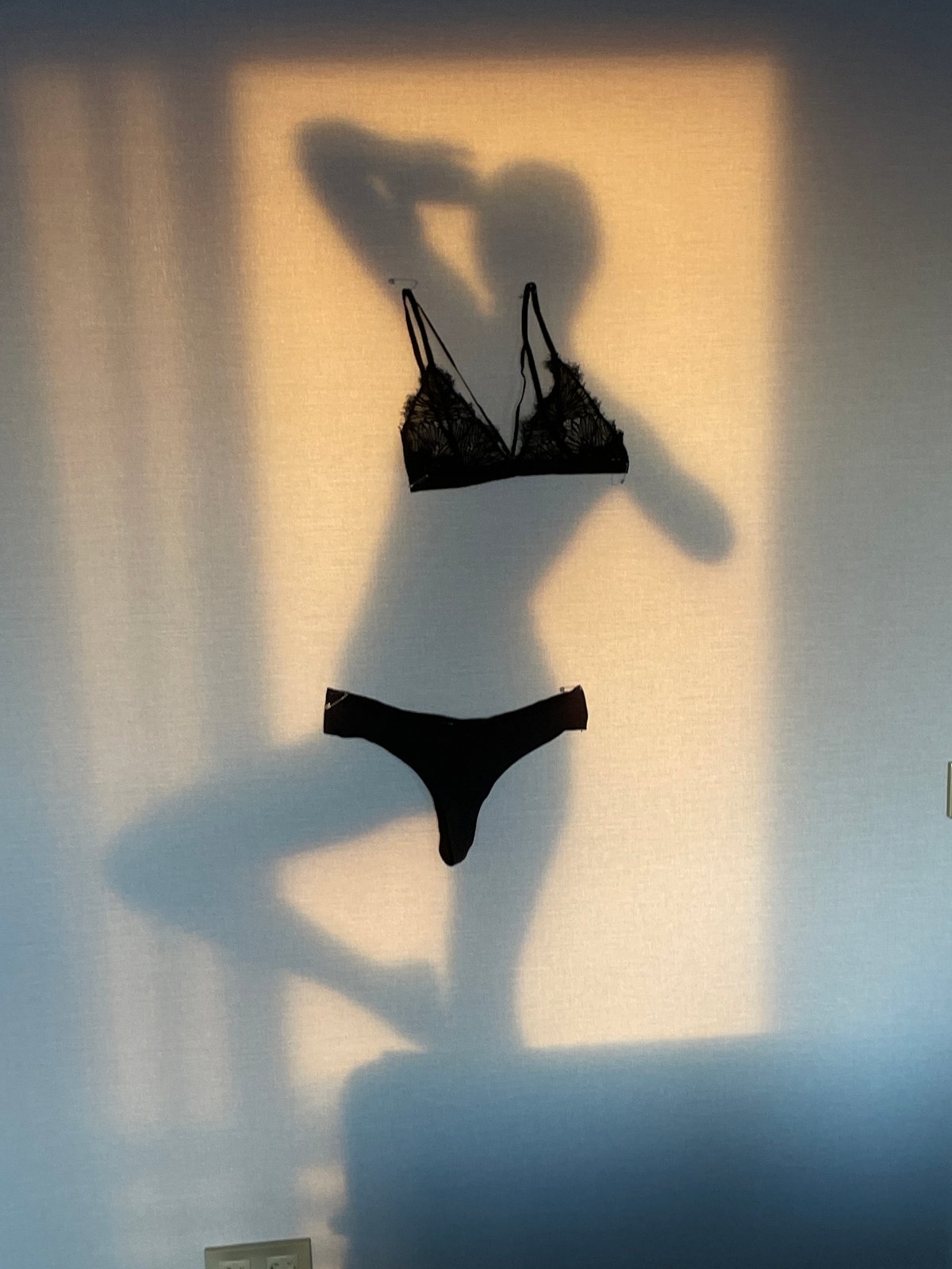 Lingerie items photographed on wall in Russian village