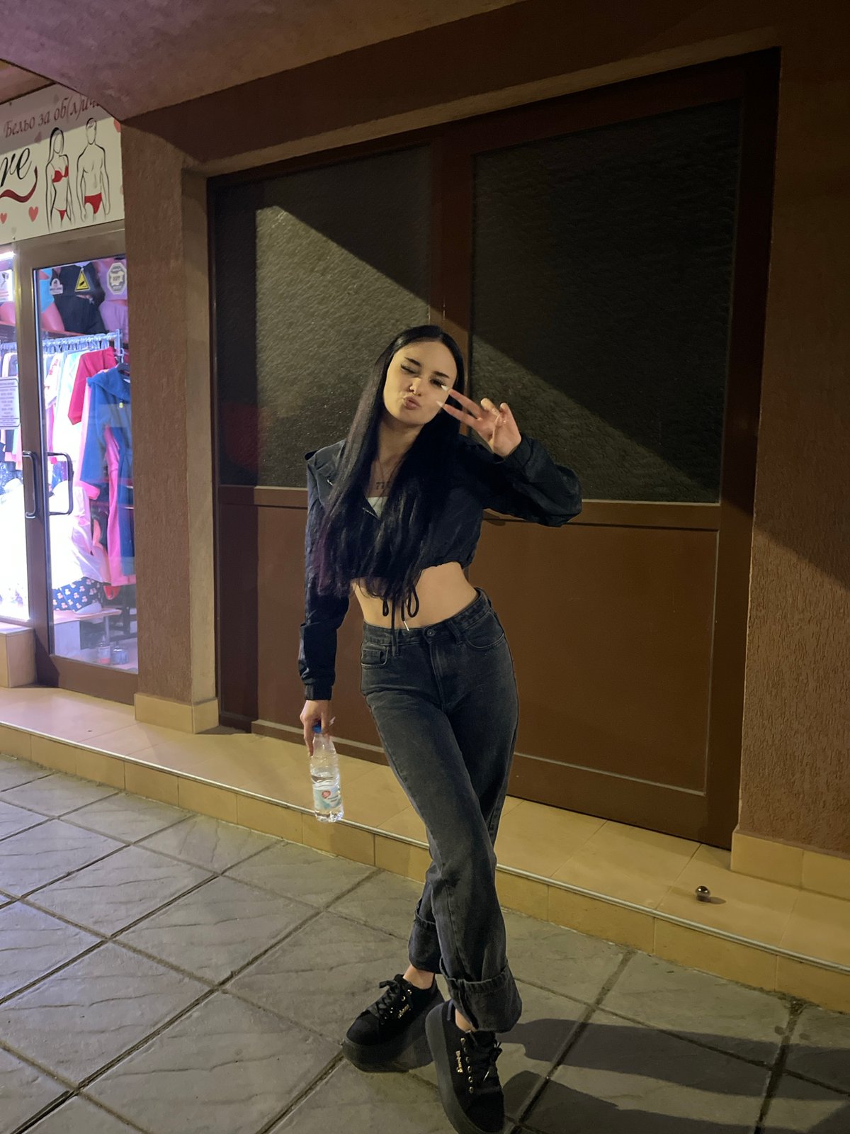 Young woman documented in evening street scenes in Elin Pelin