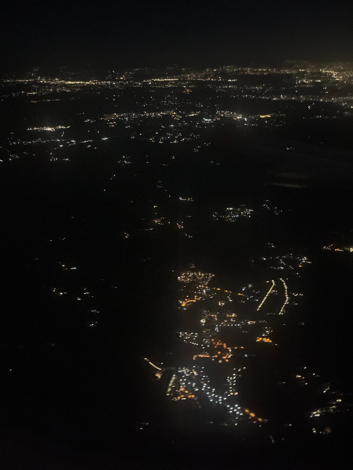 Nighttime aerial view captures city lights in Trevignano Romano