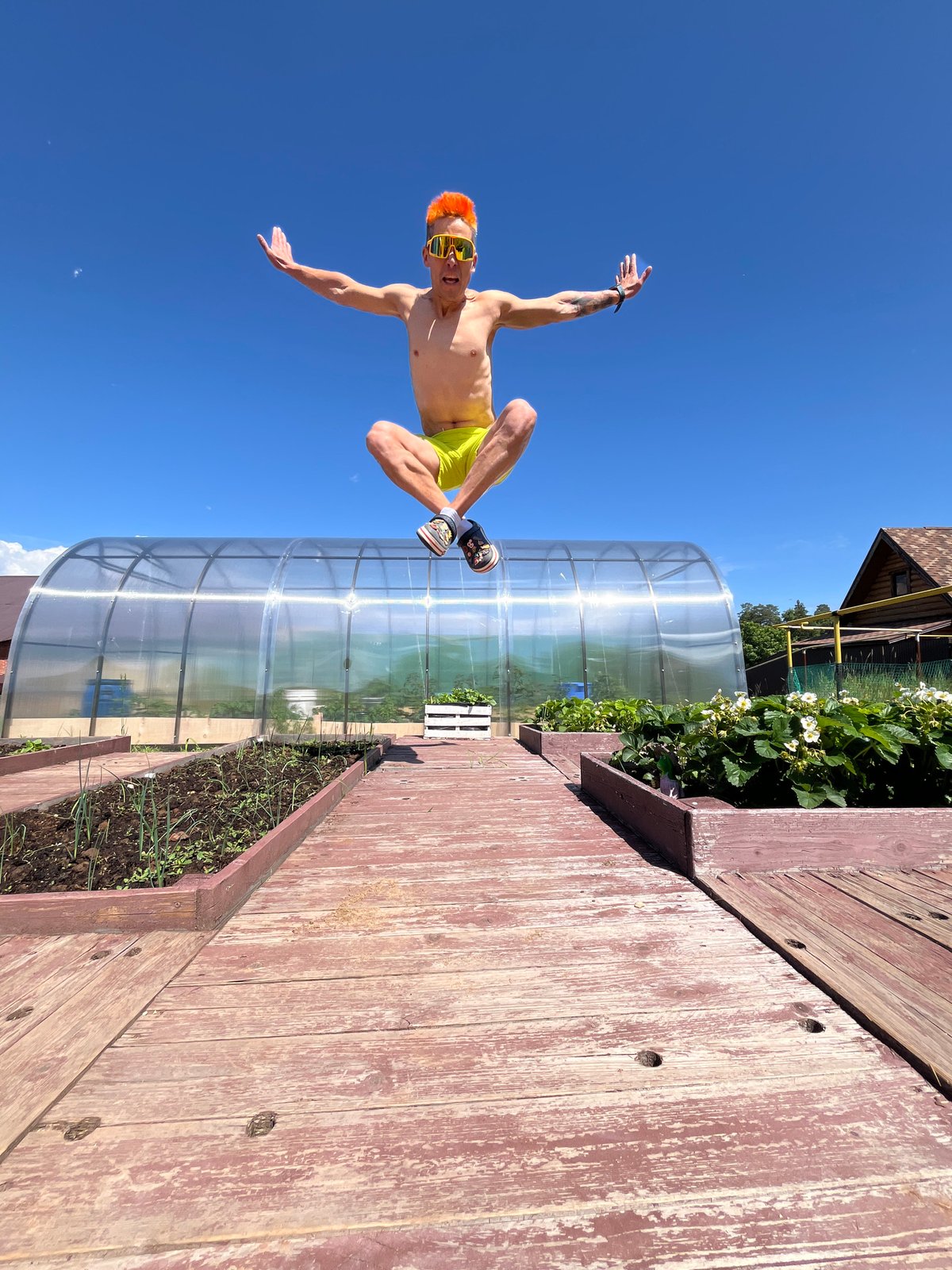 Orange-haired man photographed jumping, child plays in Chaikovsky garden
