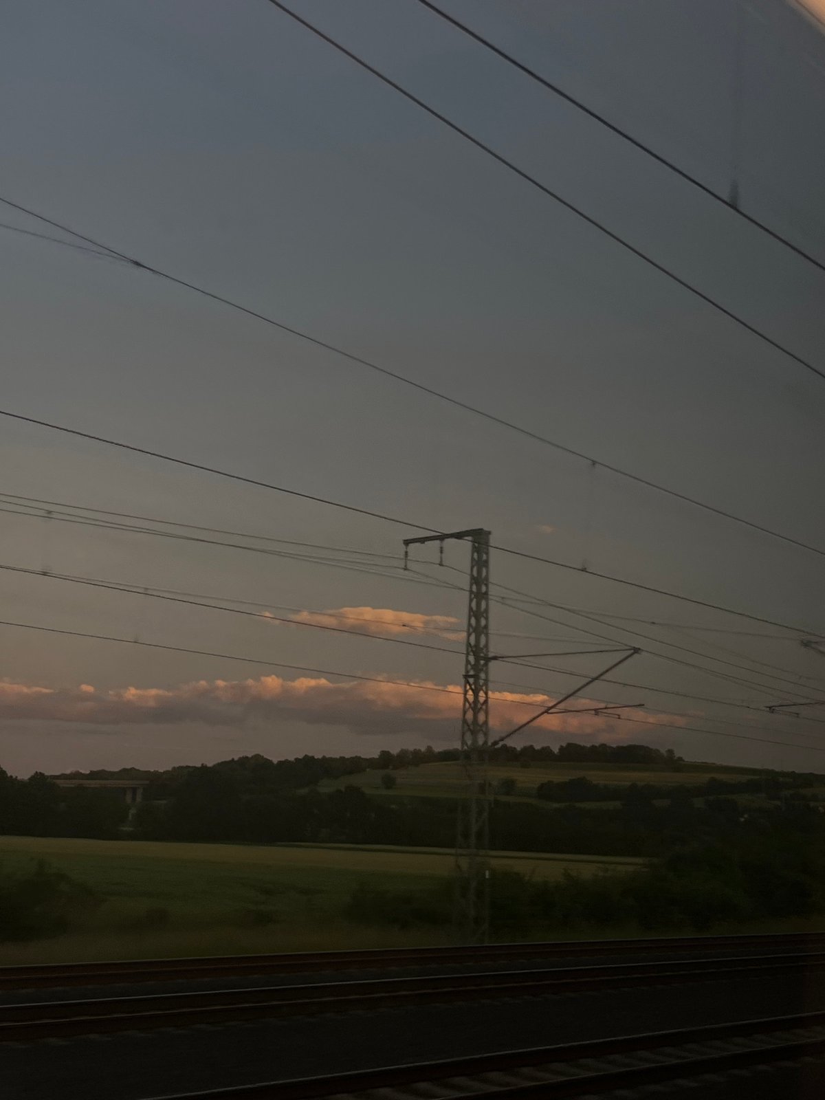 Train passenger documents 16-minute dusk journey through rural landscape