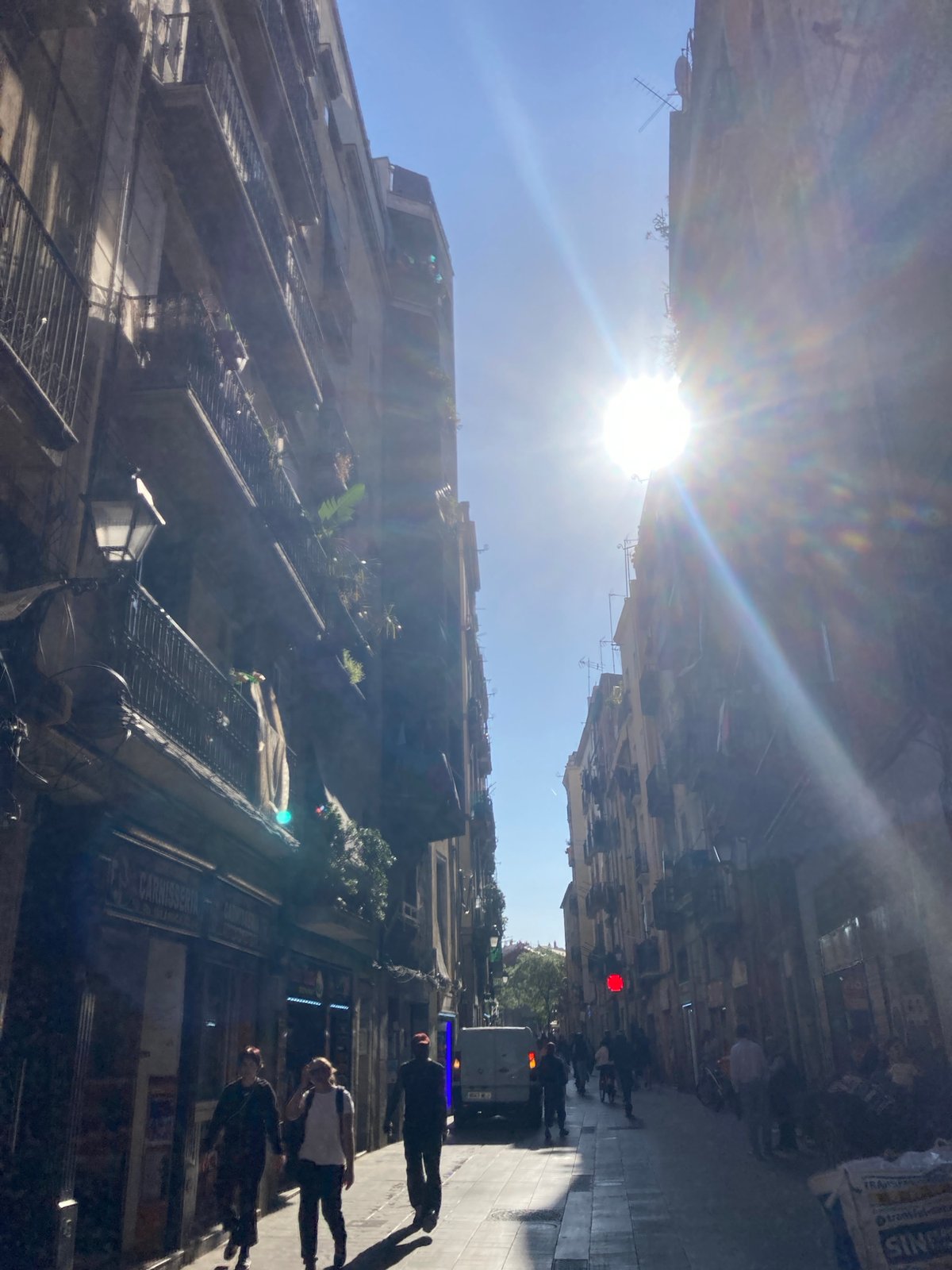 Urban street scene documented with sunlight creating lens flare
