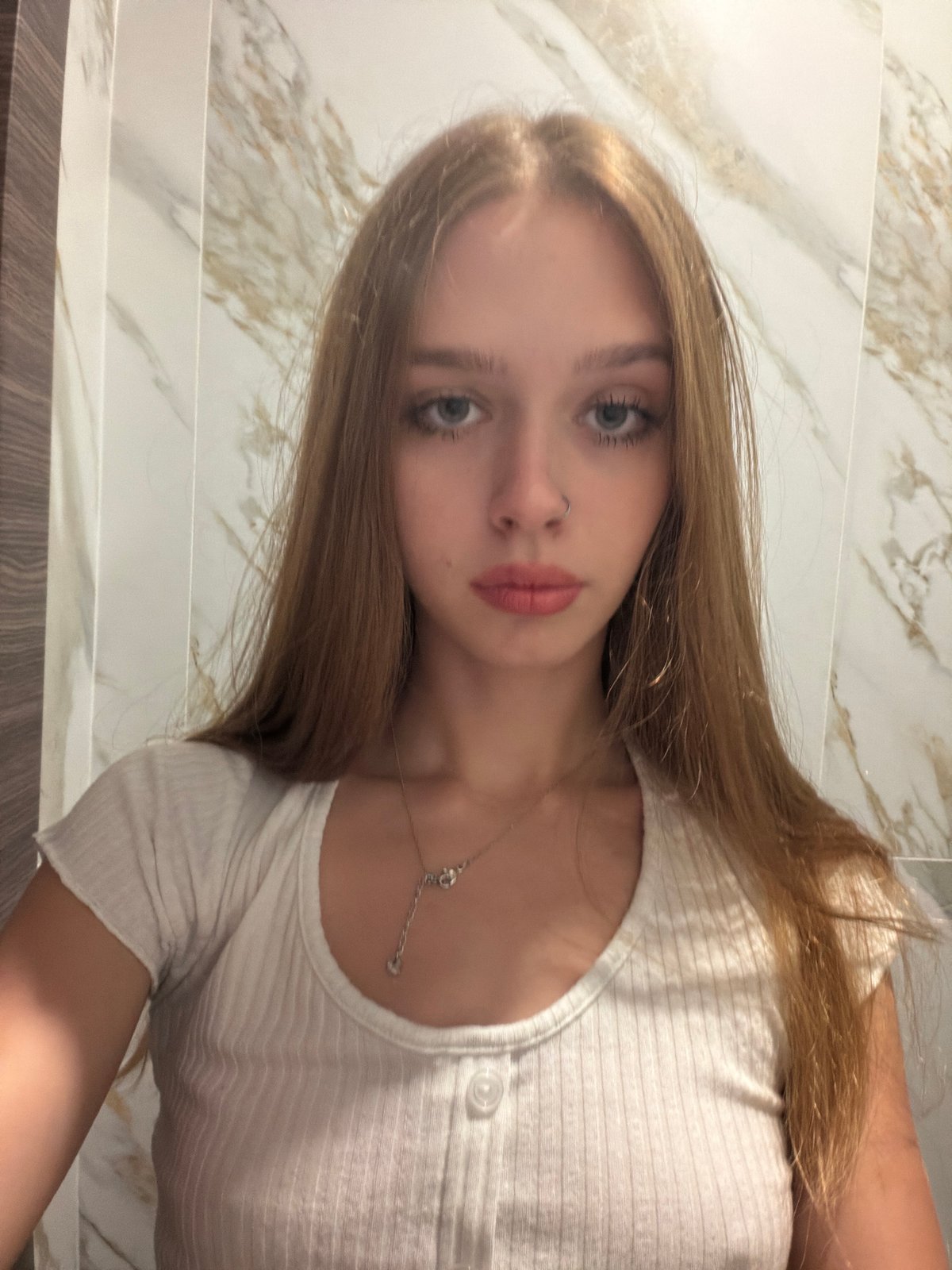 Quick selfie session in a restroom, same outfit multiple angles